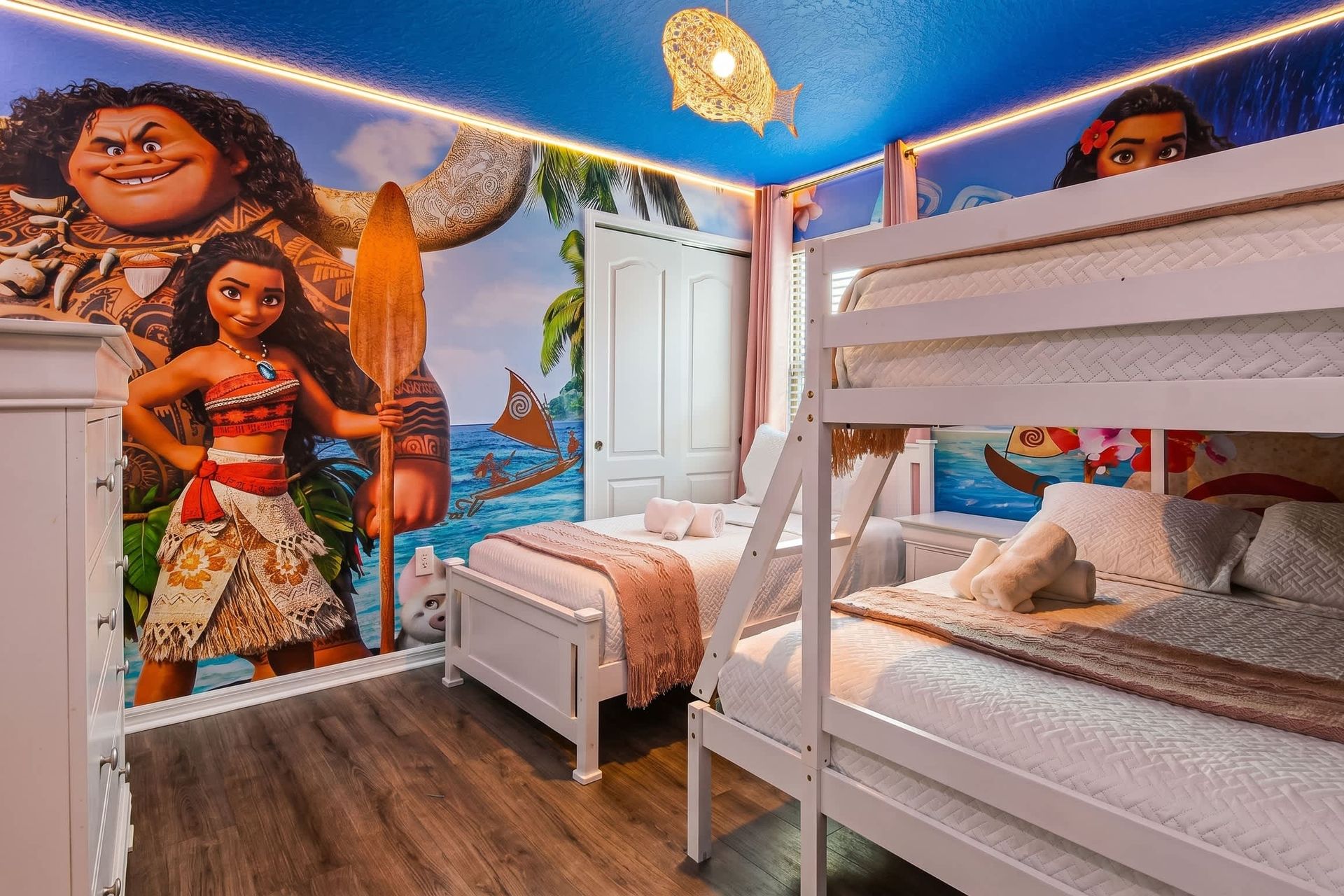 Ocean adventure-themed room with bunk beds, colorful walls, and cozy fun for kids.