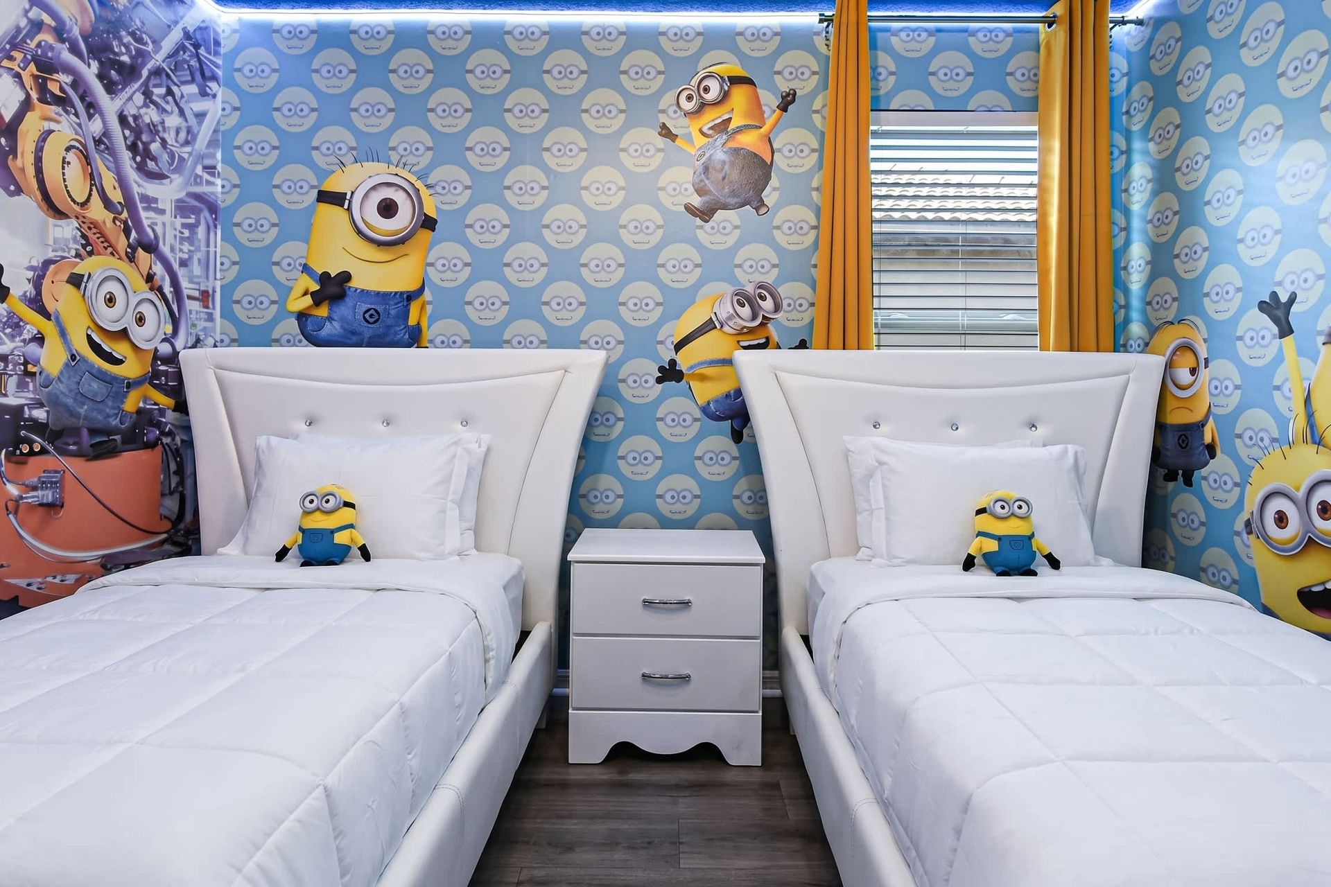 Fun Minions-themed room with twin beds, bright colors, and playful decor.