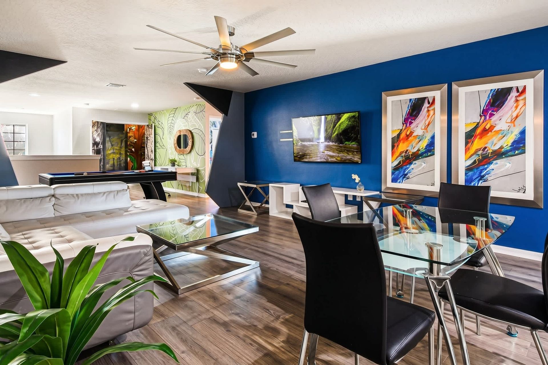 Stylish open-plan loft with bold accents, modern seating, and a sleek pool table.