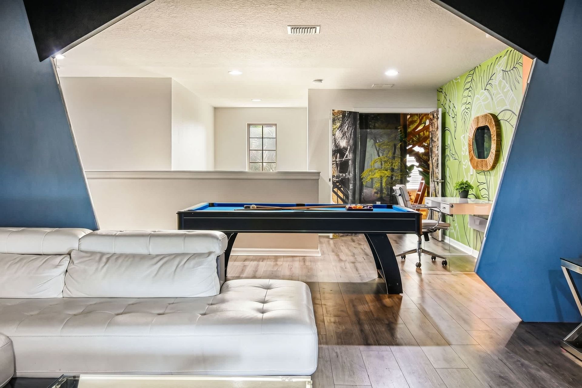 Relax, play pool, or work in this bright loft with modern style and tropical vibes.