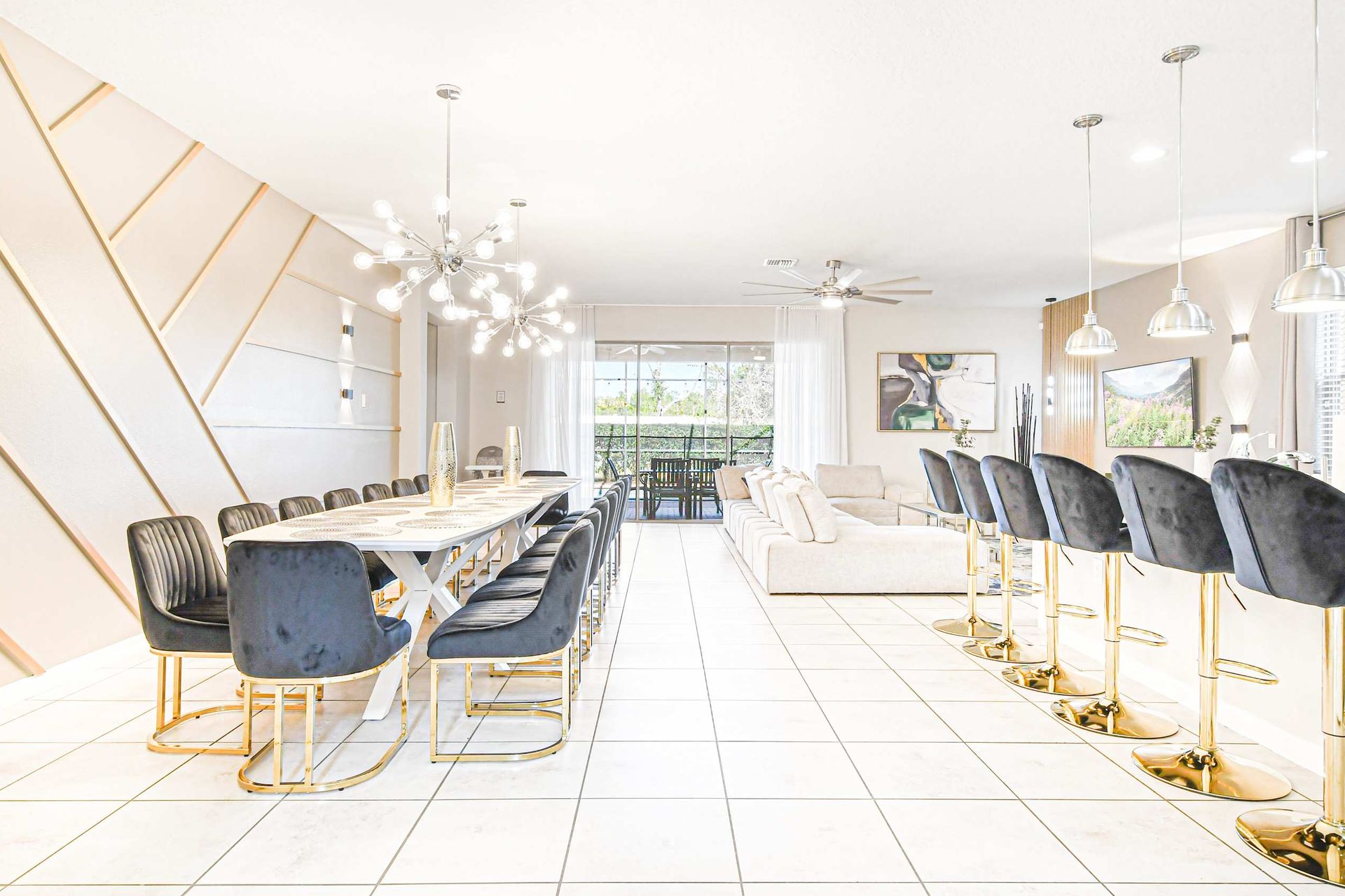 Elegant dining for twelve with designer lighting and a sleek modern open layout.