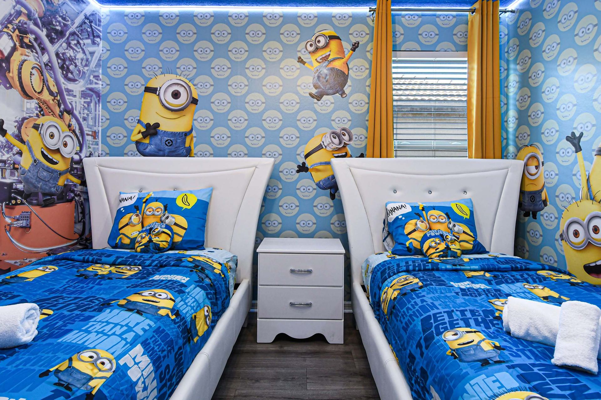 Fun Minions-themed room with twin beds, bright colors, and playful decor.