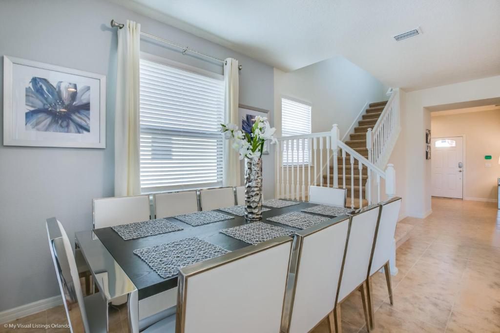 Elegant dining area with seating for 8, modern decor, and natural light.