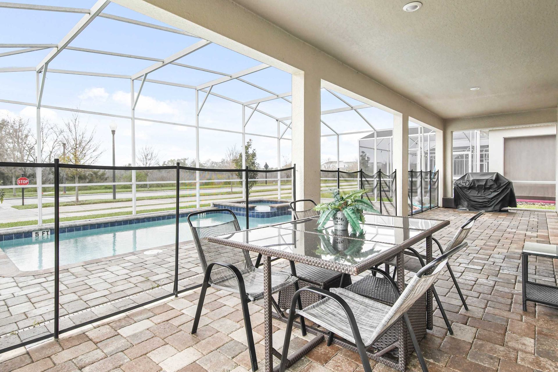 Host poolside dinners and BBQs in style! Enjoy the spacious screened patio with a view.