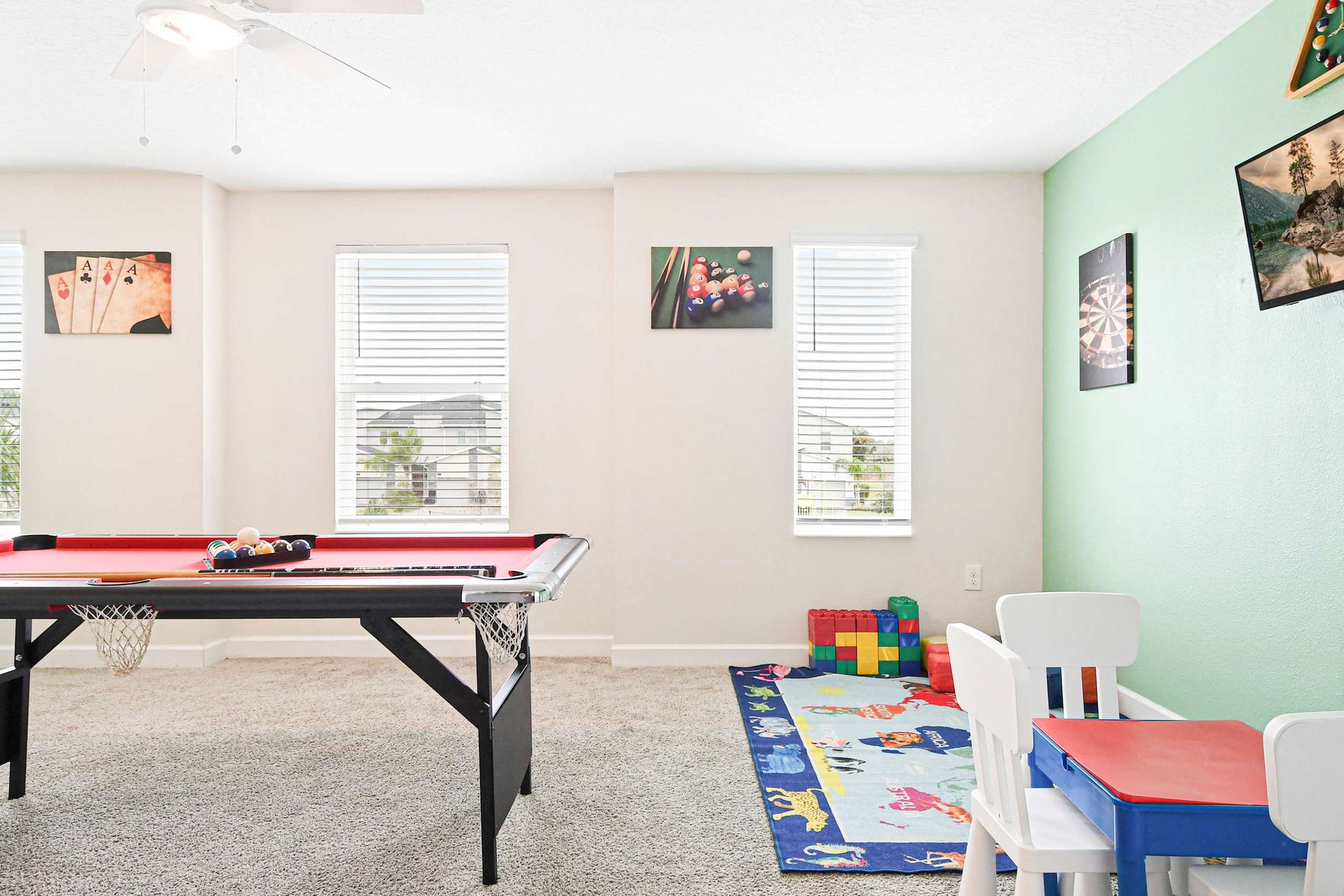 Fun-filled game room with a pool table, kids' play area, and bright decor for endless entertainment.