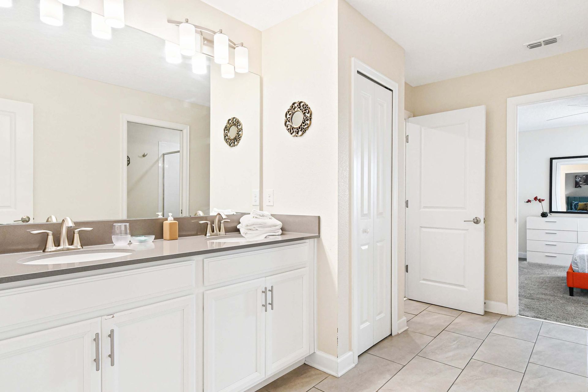 Bright and elegant bathroom with double sinks, modern fixtures, and ample space for your essentials!