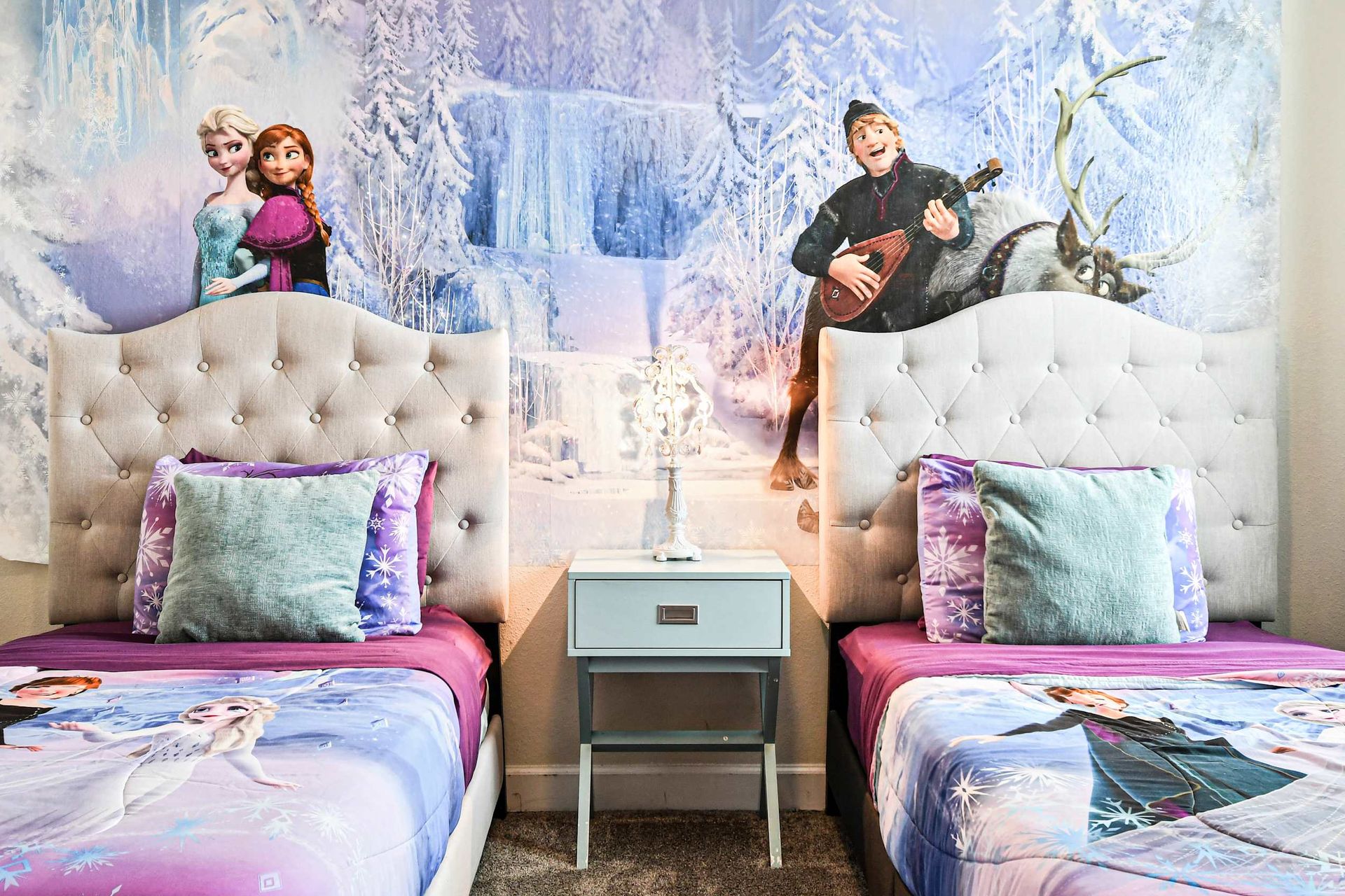 Enchanting Frozen-themed bedroom with cozy beds, magical decor, and a whimsical winter mural.