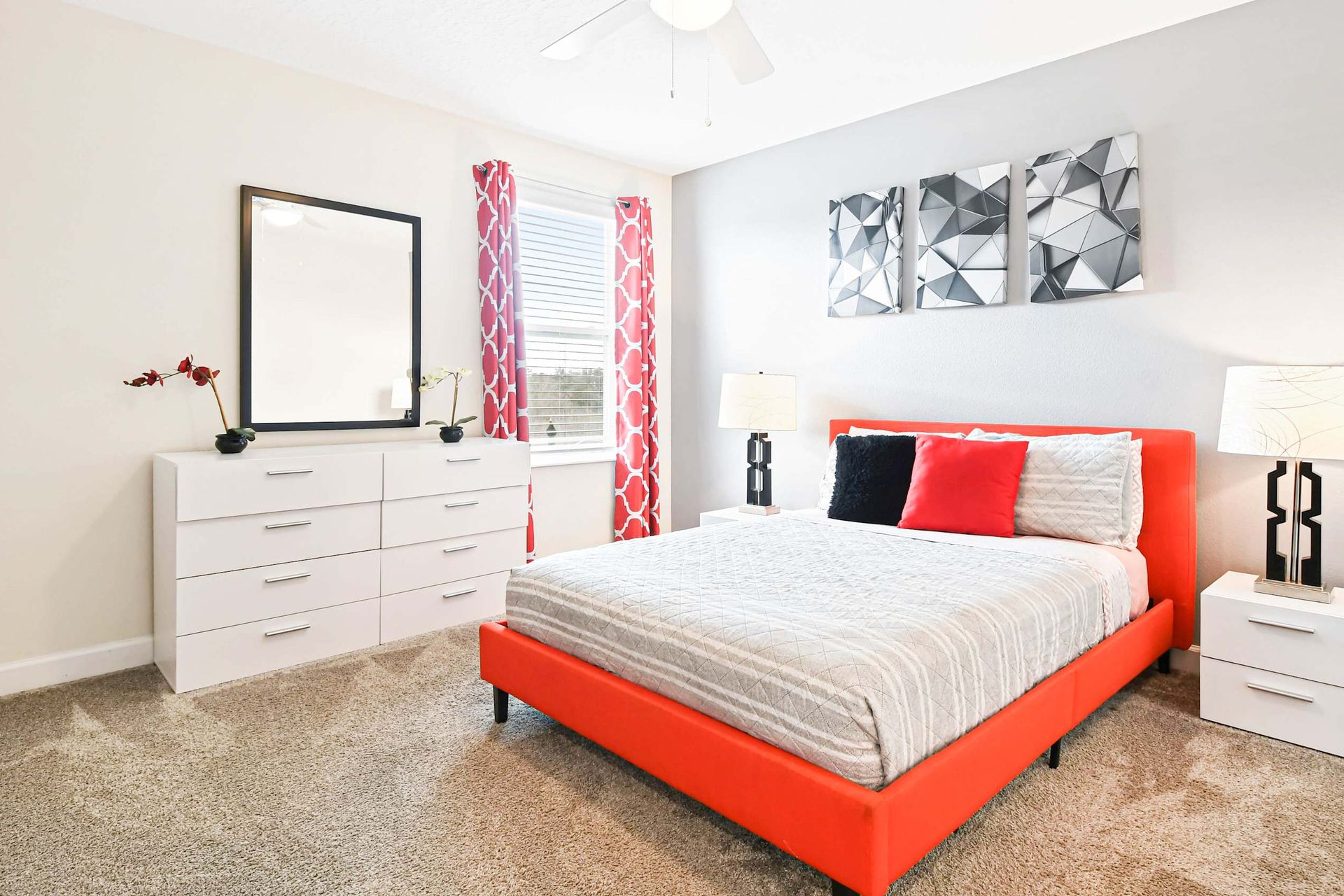 Modern bedroom with a pop of red! Sleek decor and cozy vibes make this room a stylish retreat.
