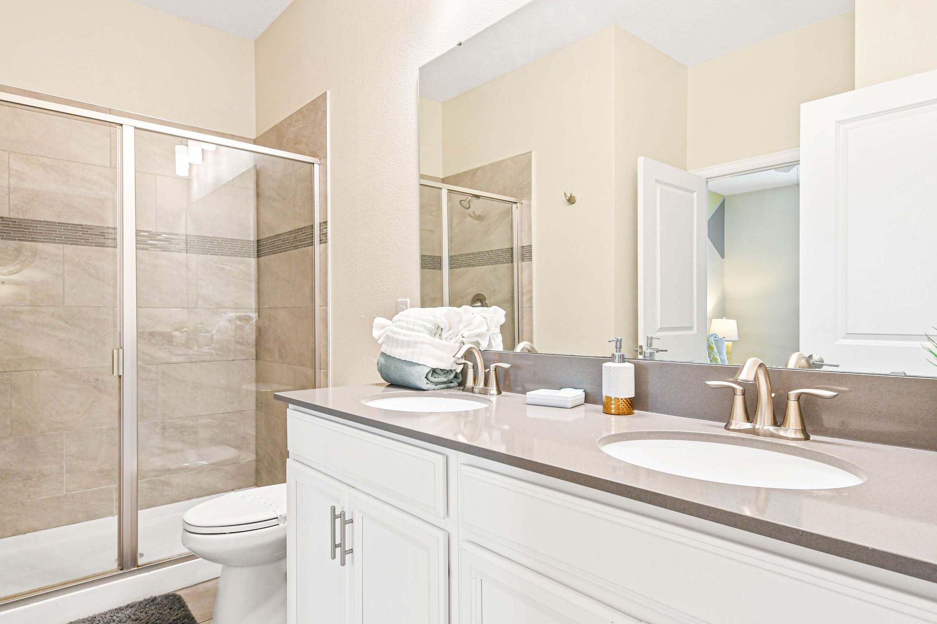 Spacious bathroom with double sinks and a sleek, modern shower perfect for a relaxing retreat!