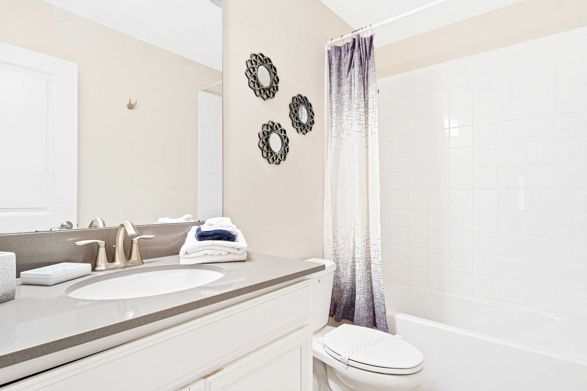 Bright and modern bathroom with elegant decor and a cozy shower-tub combo for ultimate relaxation!