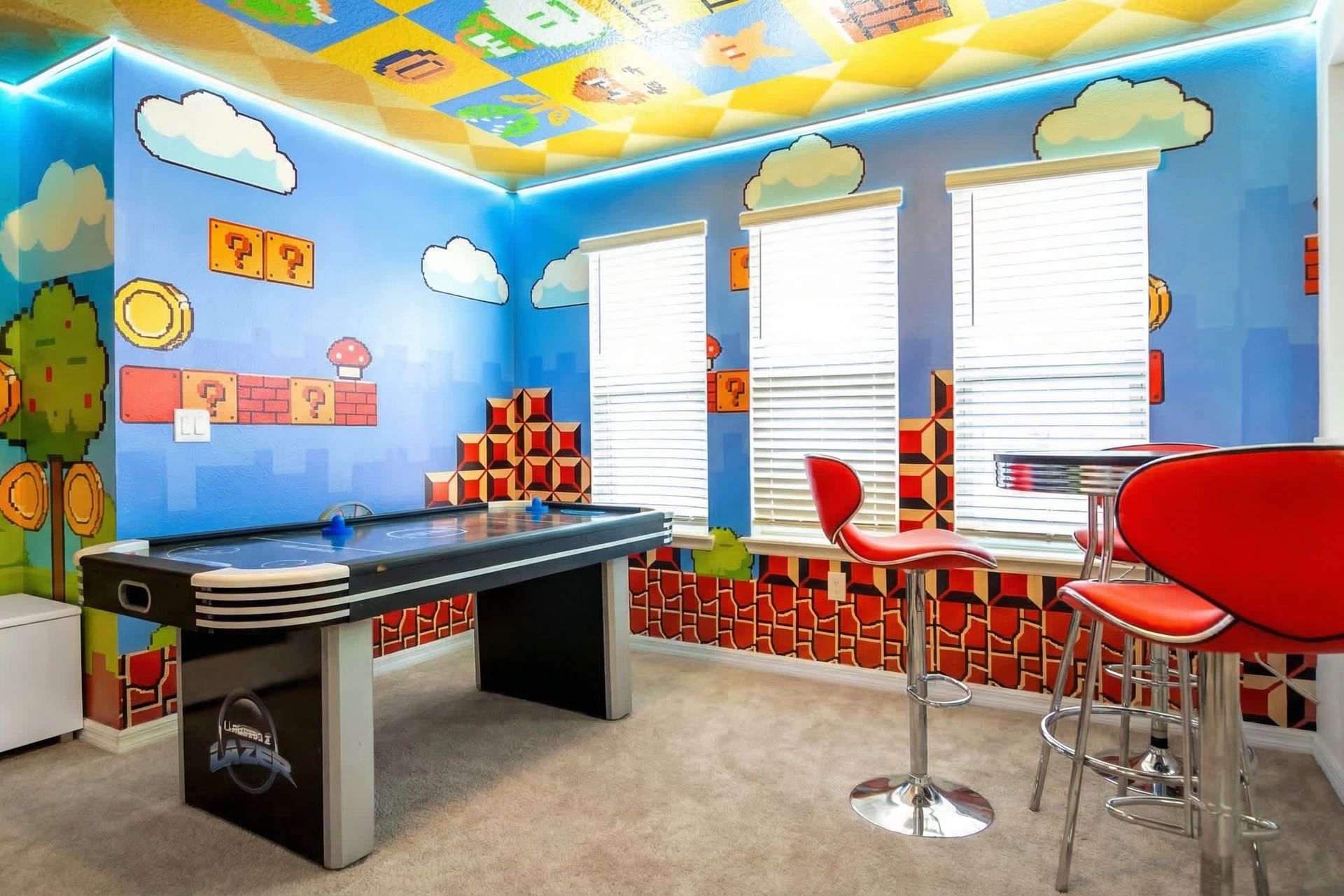 Fun-filled game room with air hockey, bar seating, and bold themed walls.