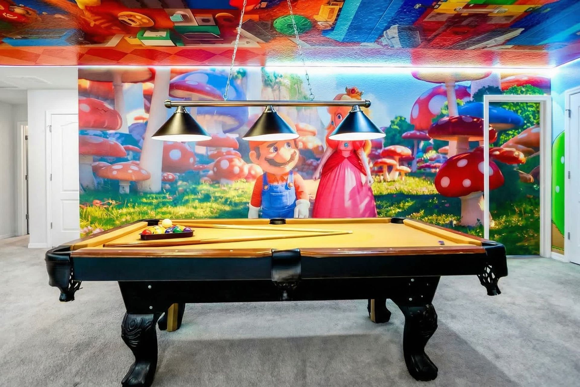 Themed game room with pool table, colorful murals, and playful atmosphere.