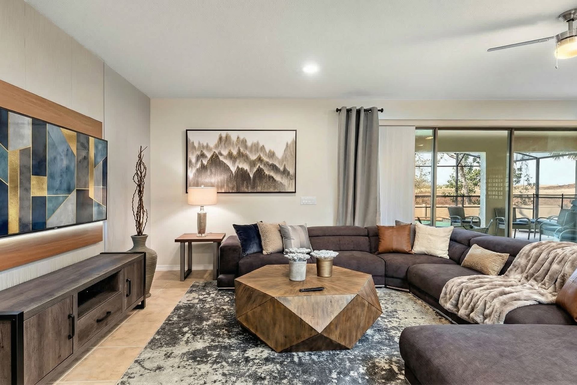 Modern living room with cozy sectional, smart TV & pool views!