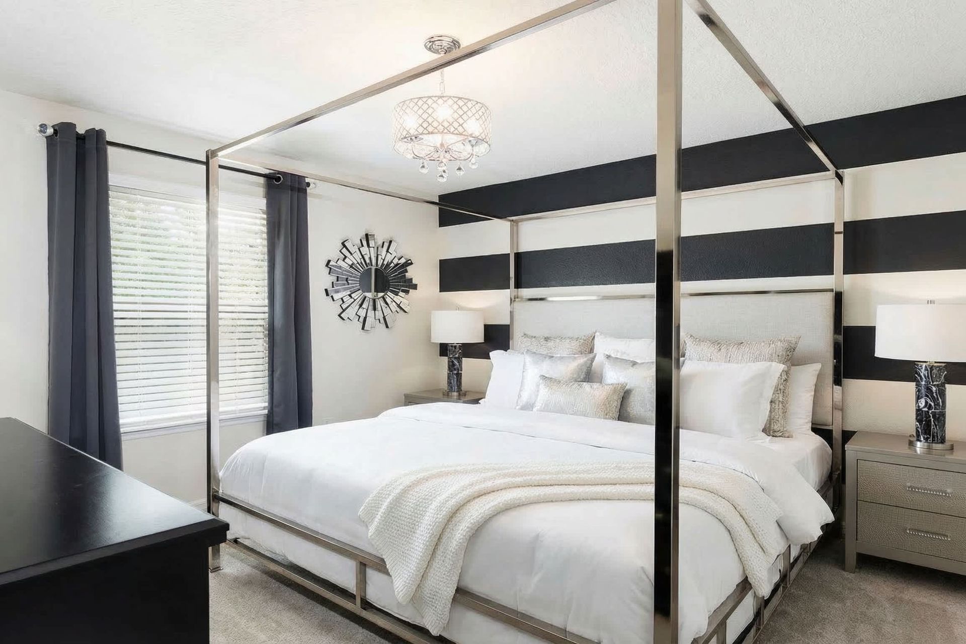 Modern chic bedroom with striped walls, canopy bed, and bold decor!