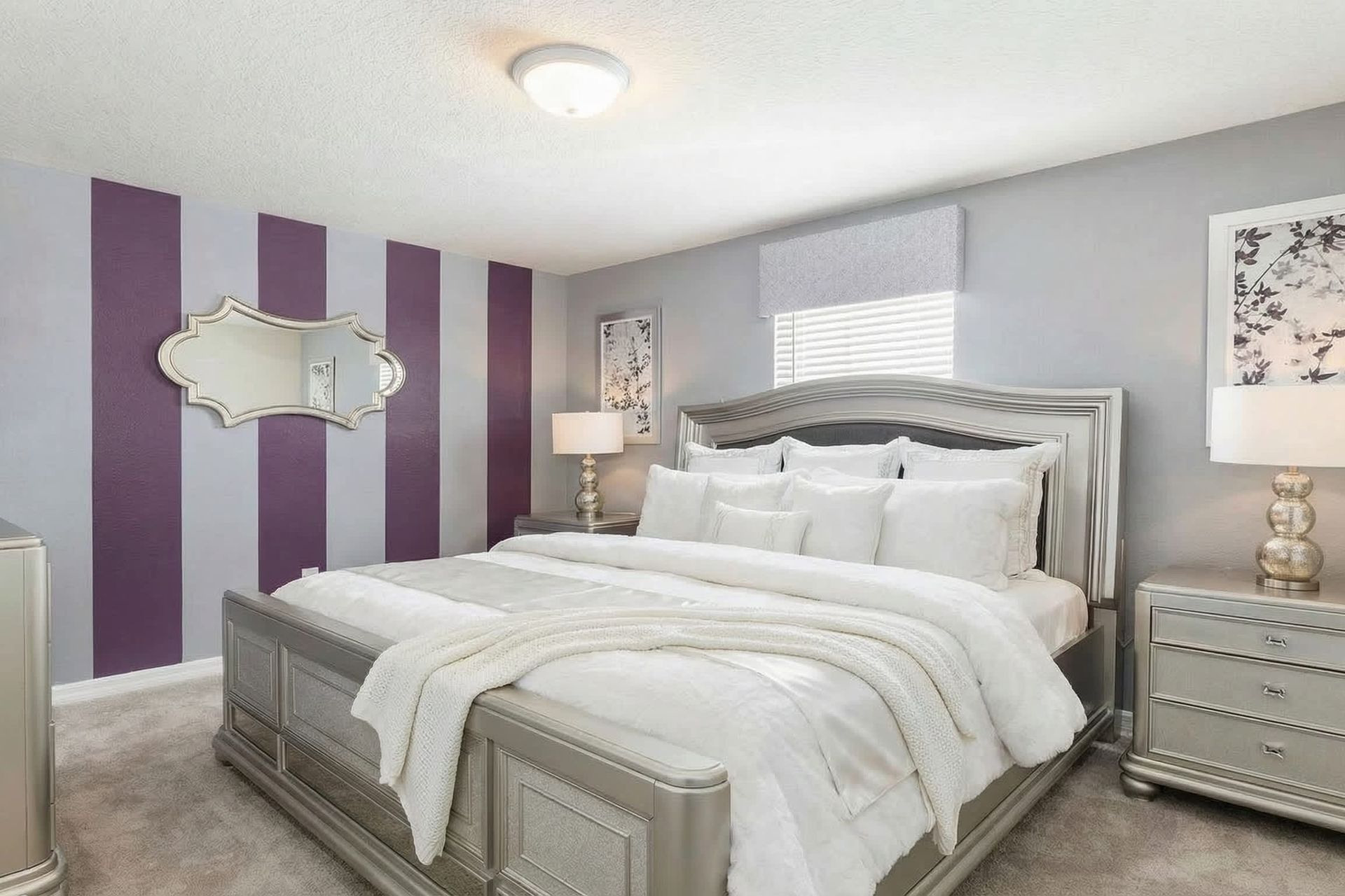 Elegant bedroom with bold purple stripes, luxe decor, and king bed!