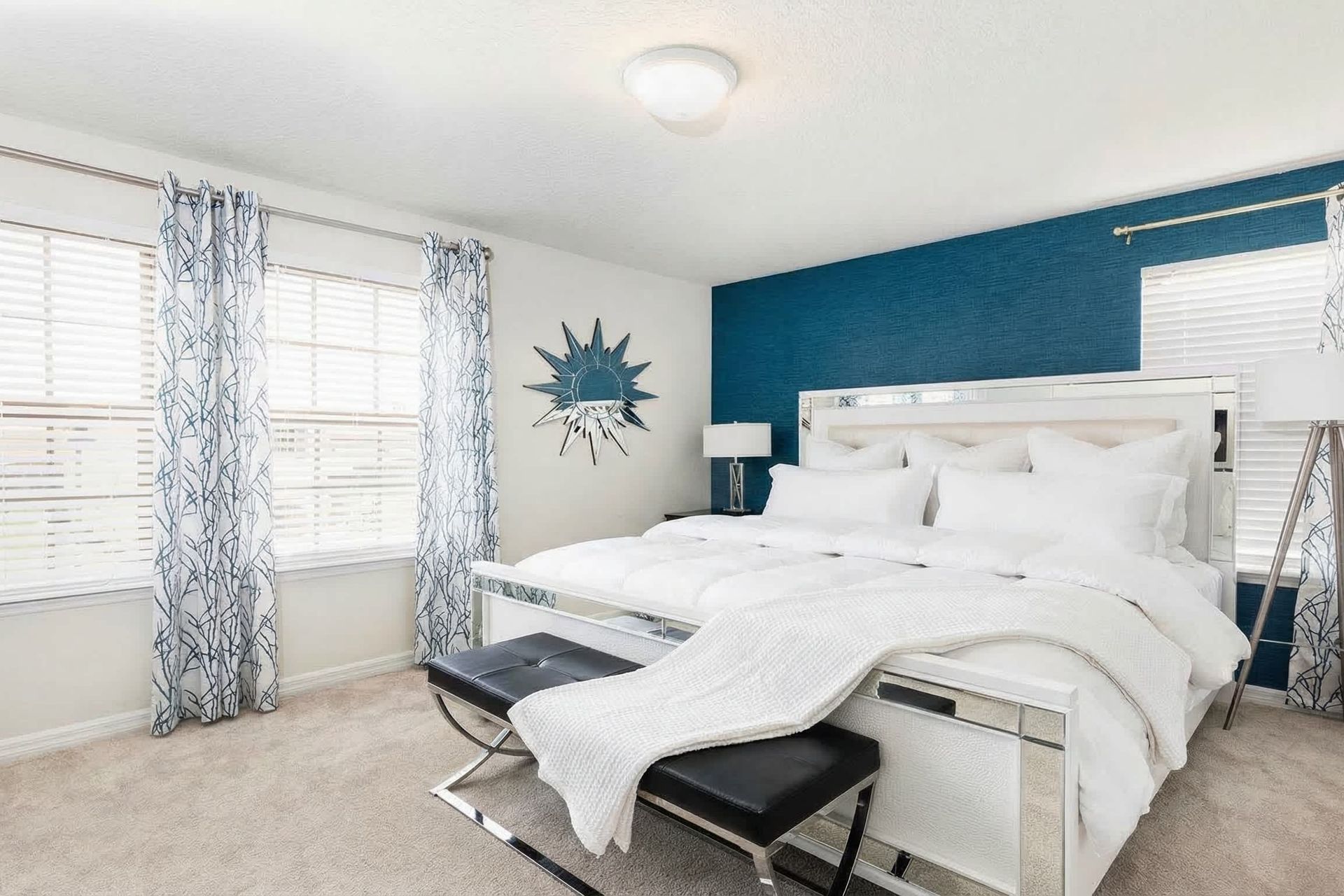 Elegant master bedroom with king bed, bold accents, and natural light!