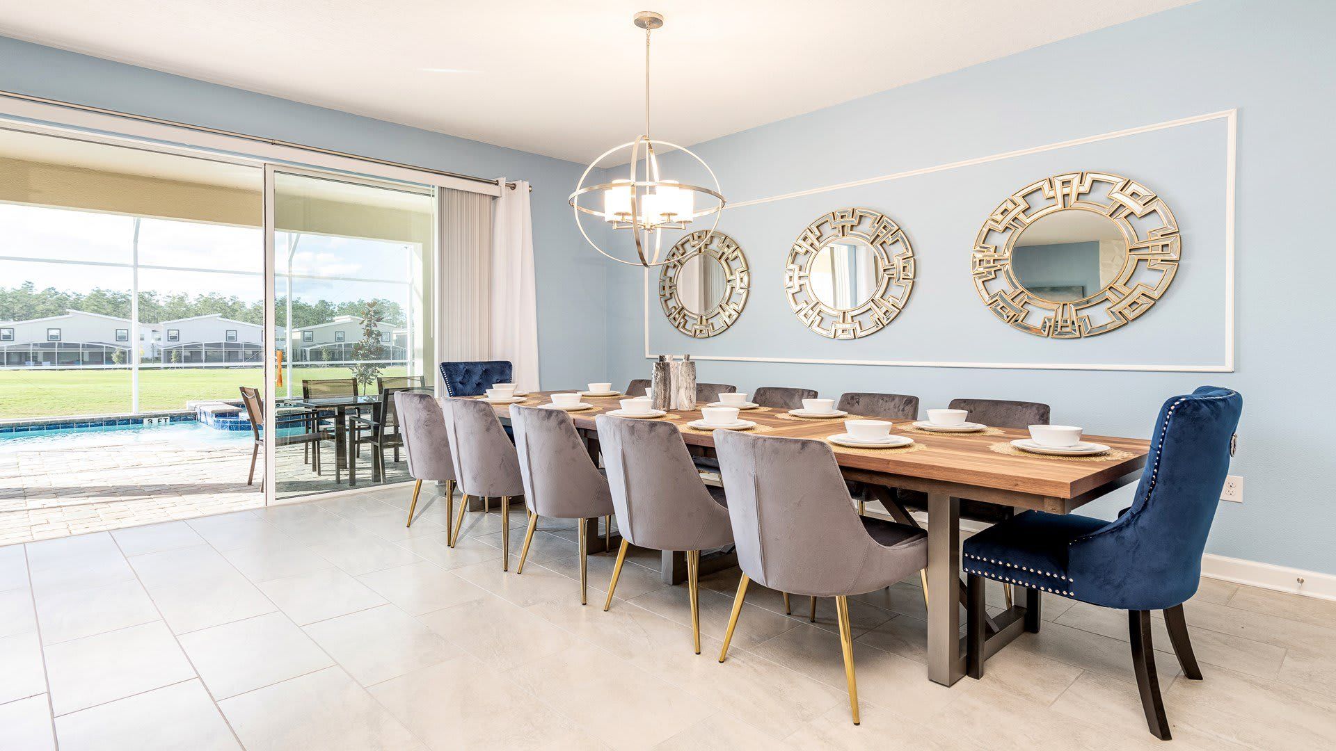 Elegant dining area with seating for 10, stylish decor, and pool view.