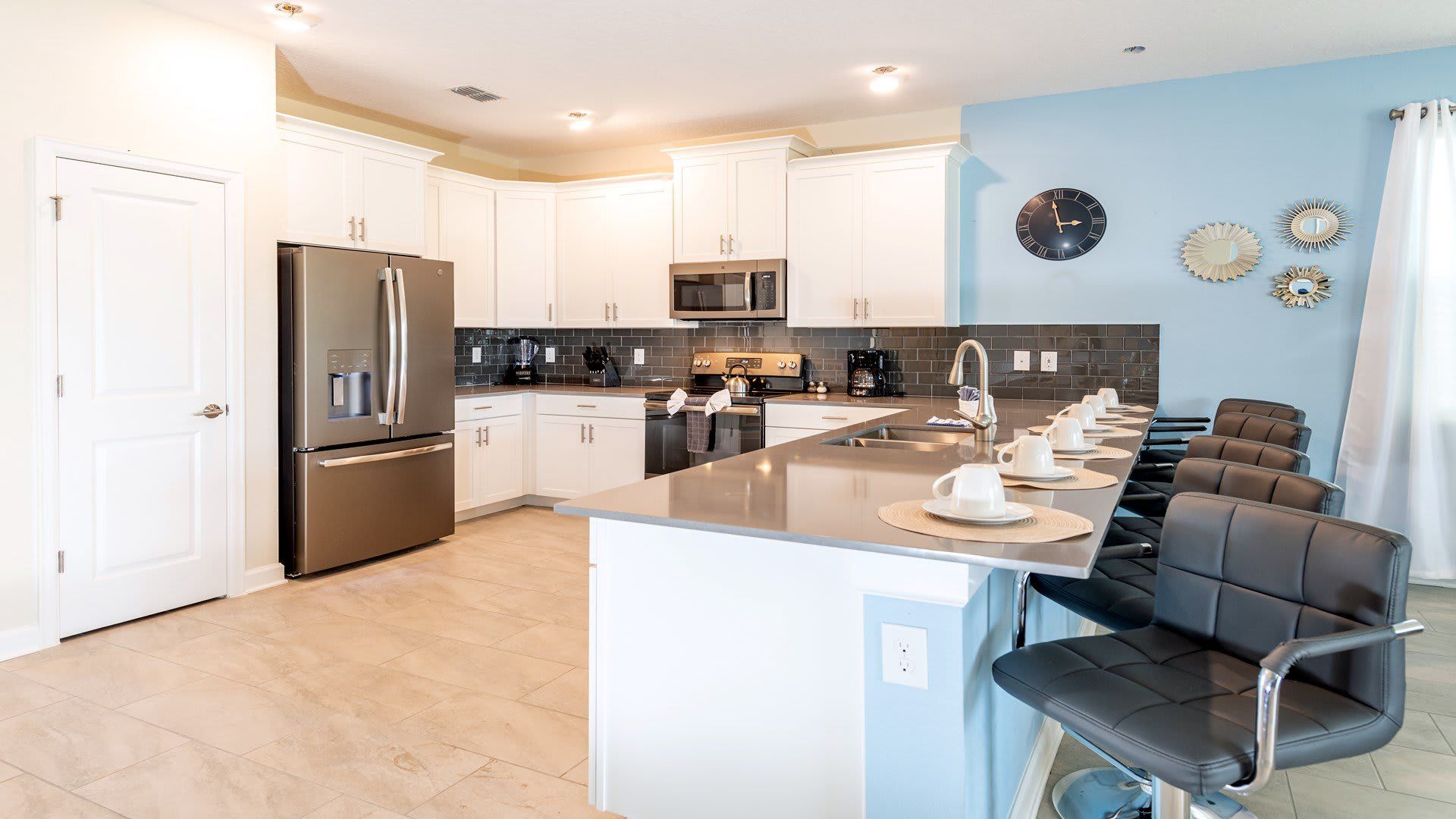Bright, modern kitchen with sleek design and pops of blue.
