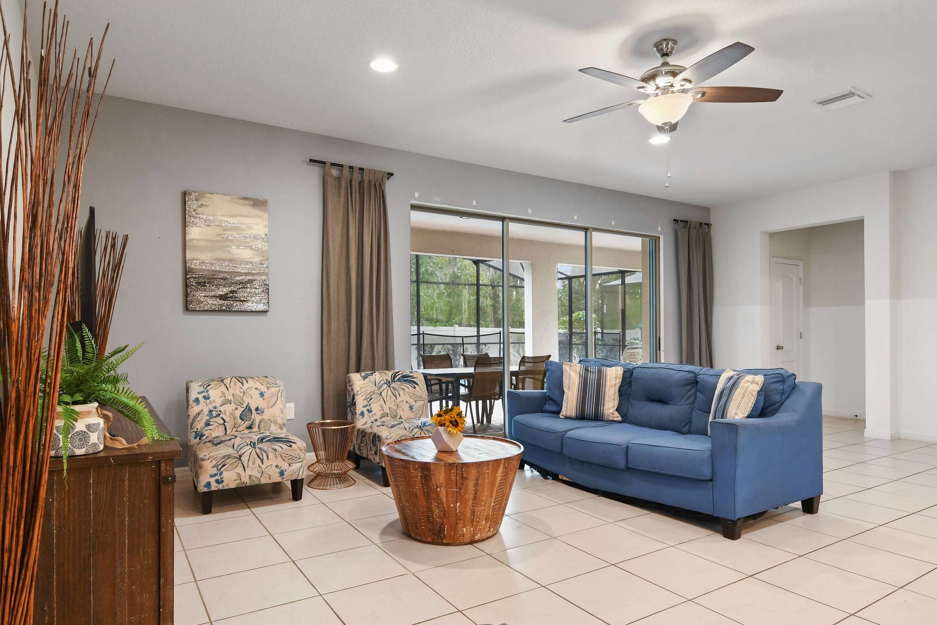 Comfortable seating area with views of the screened patio and private pool.