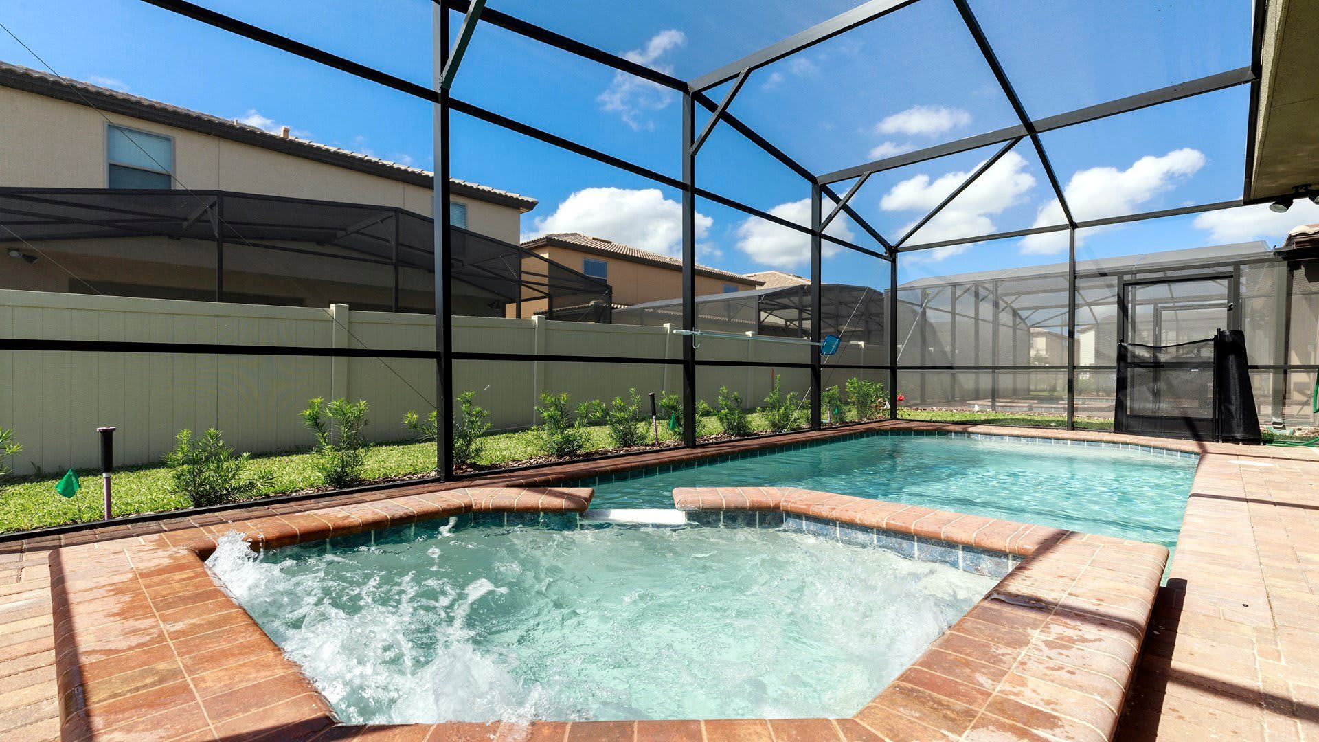 A luxurious outdoor pool surrounded by stylish seating arrangements.