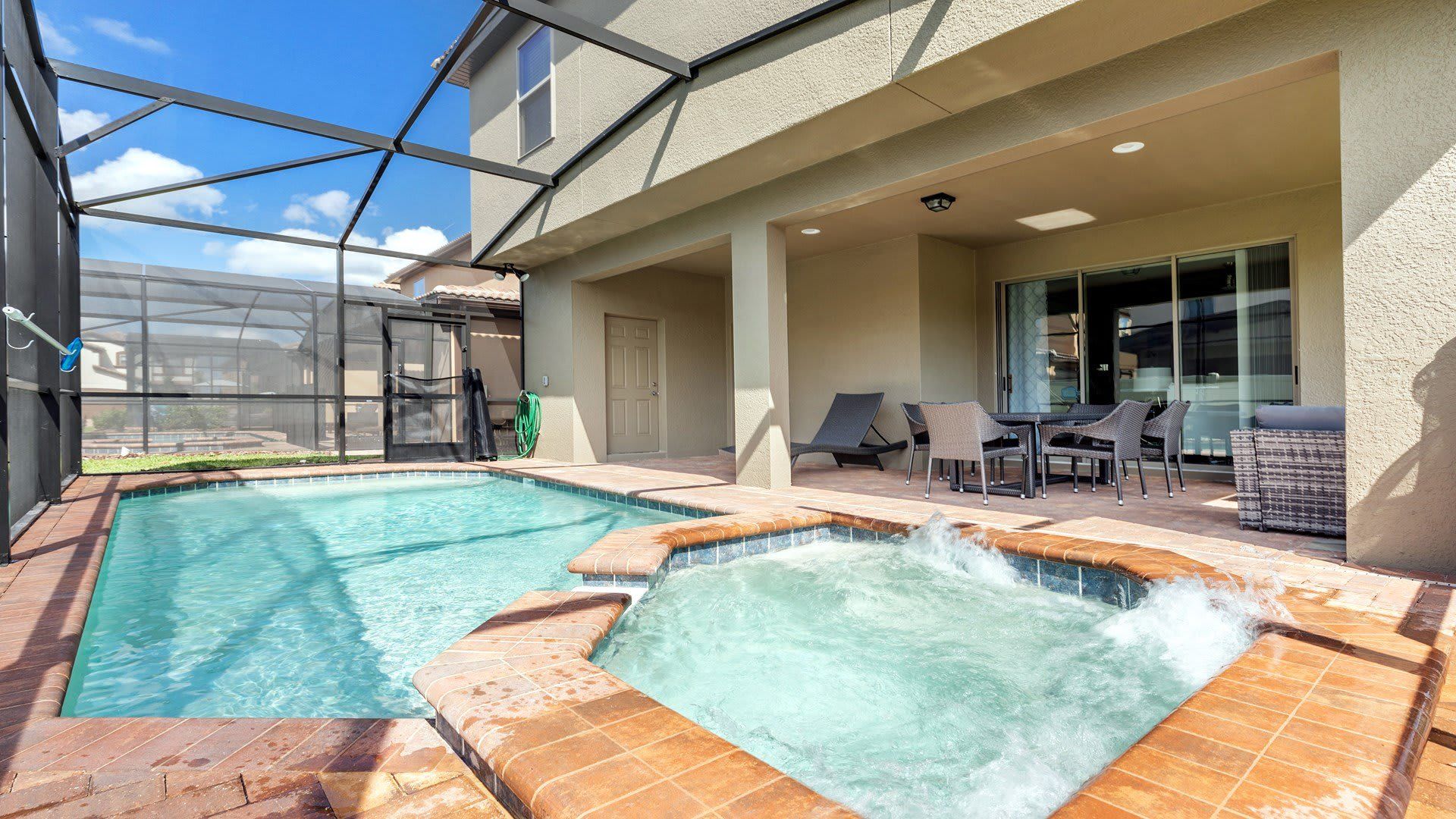 A luxurious outdoor pool surrounded by stylish seating arrangements.