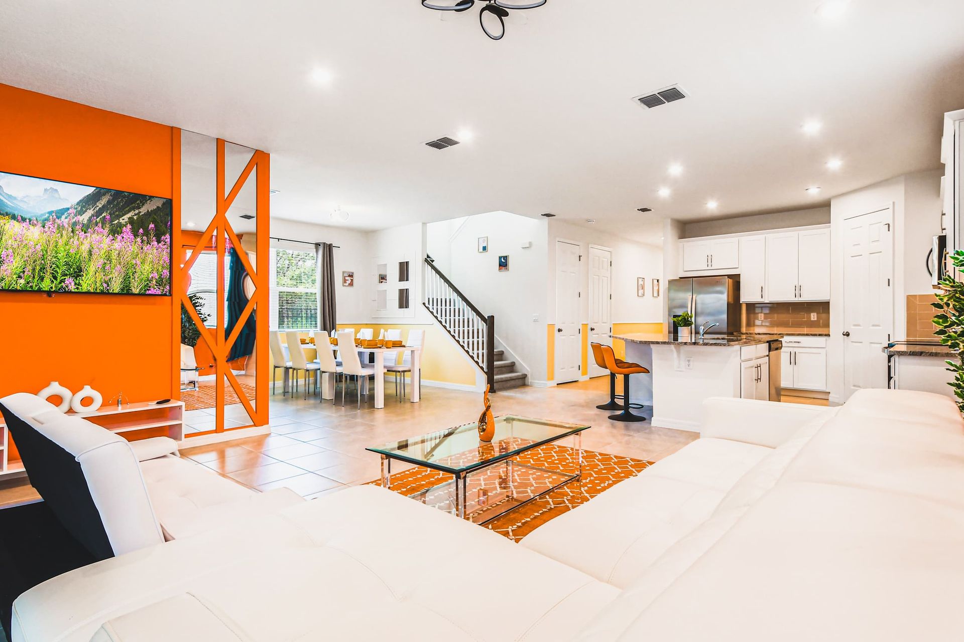 Bright open-concept living with bold accents, full kitchen, and dining for ten.
