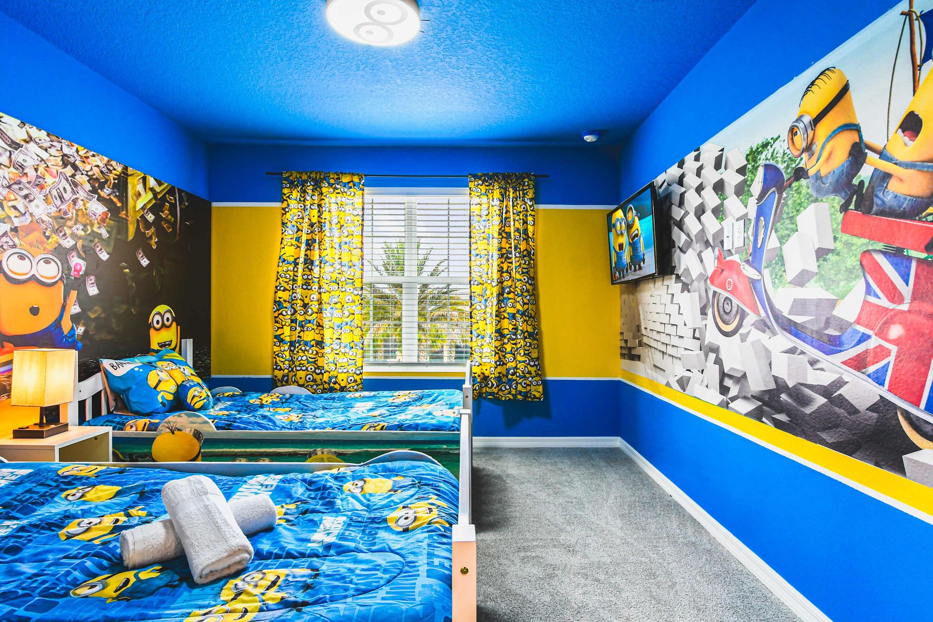 Fun Minions-themed twin room with vibrant decor, colorful bedding, and TV entertainment.