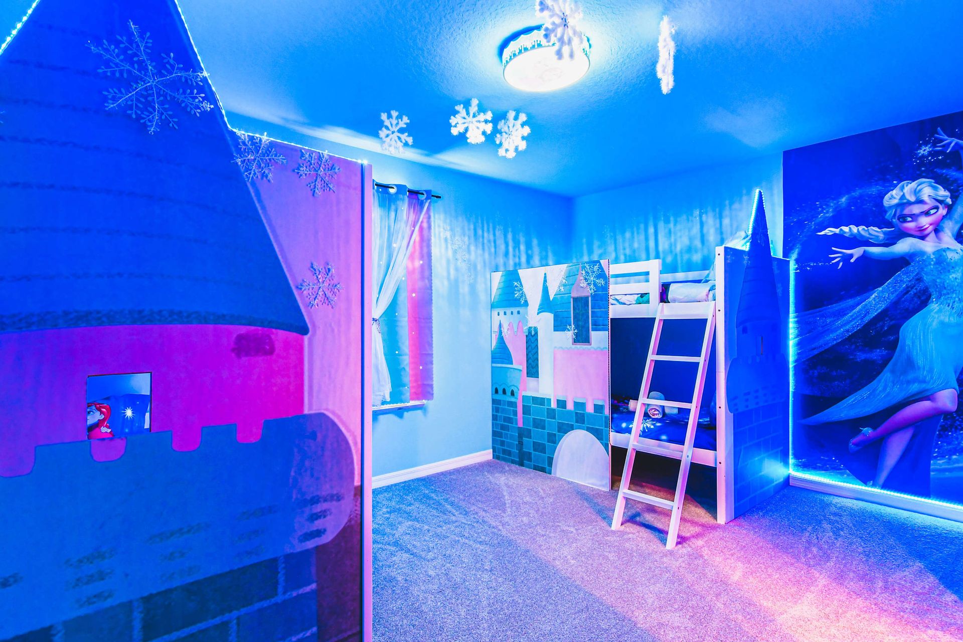 Frozen-themed bunk room with castle beds, glowing snowflakes, and magical vibes.