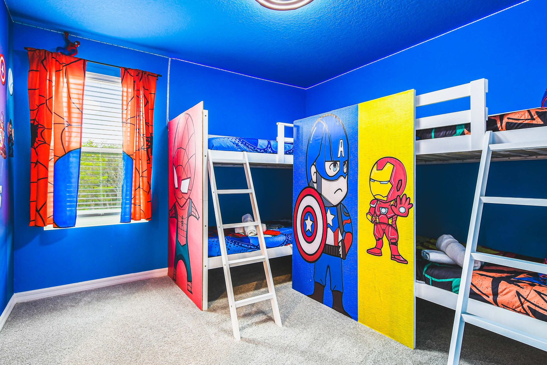 Superhero bunk room with bold Avengers decor, themed beds, and playful energy.
