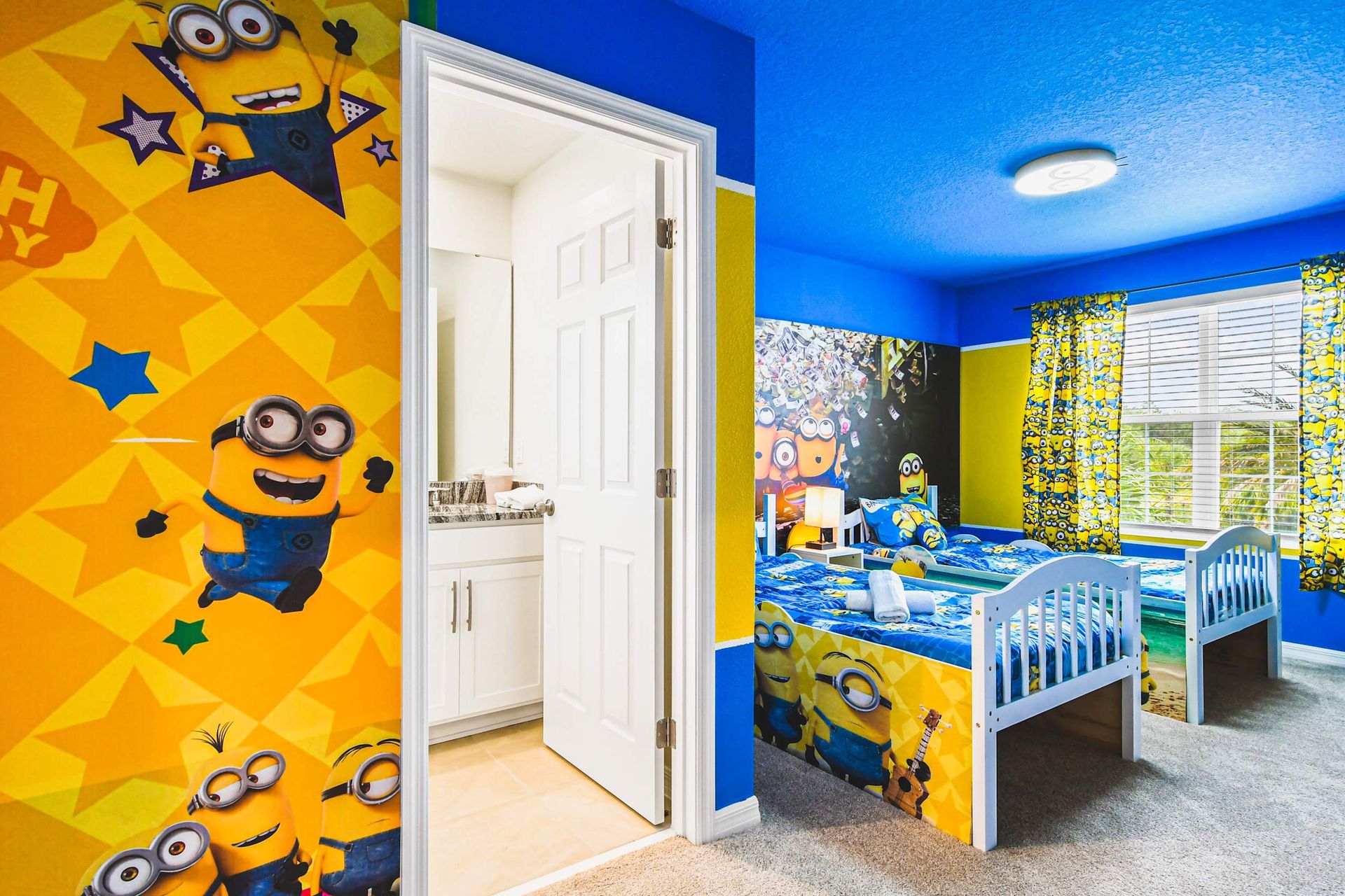 Minions-themed twin room with bright colors, playful decor, and private bathroom.
