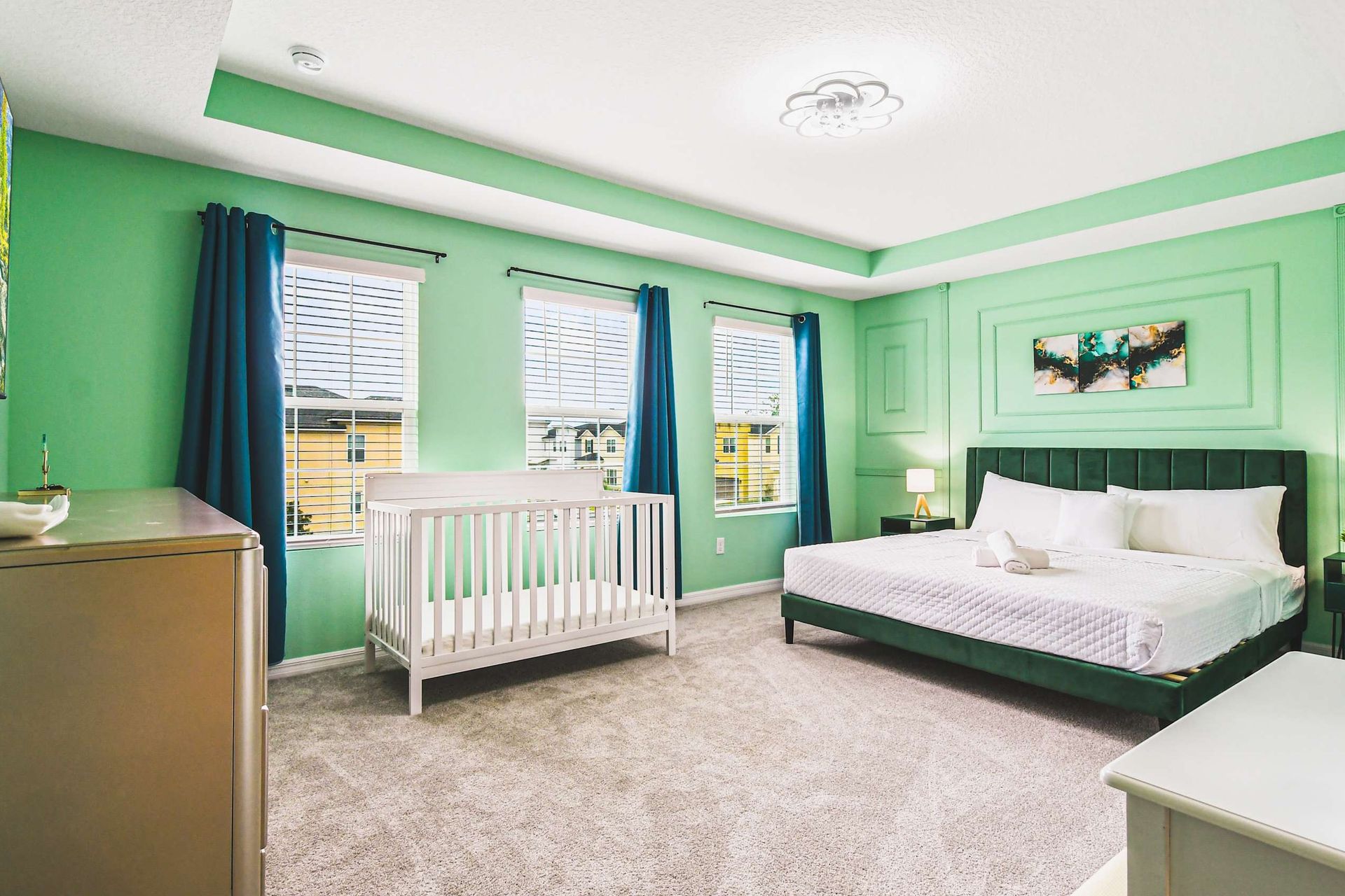 Spacious king suite with crib, cozy decor, natural light, and family comfort.