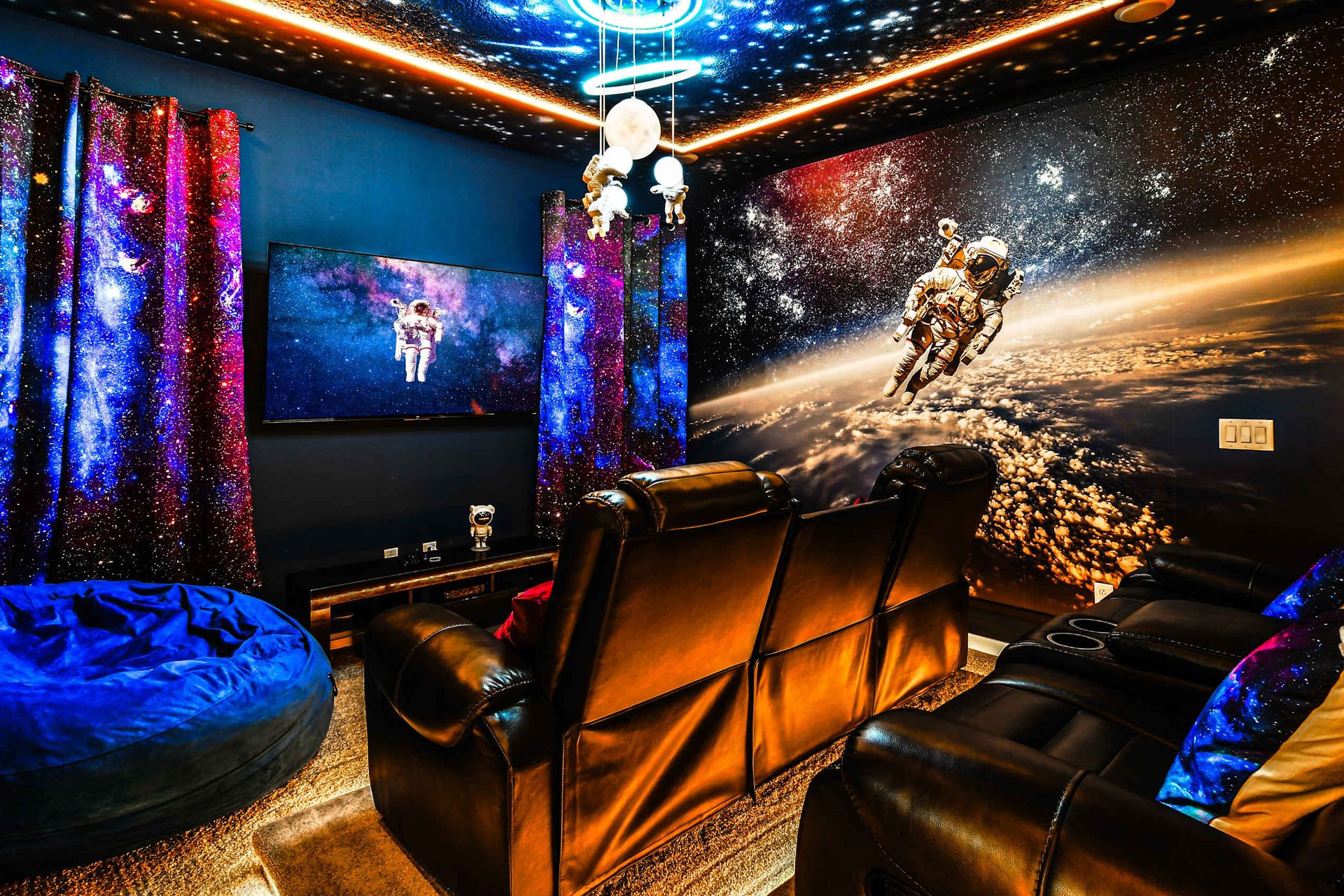 Space-themed home theater with cosmic vibes and cozy seating!