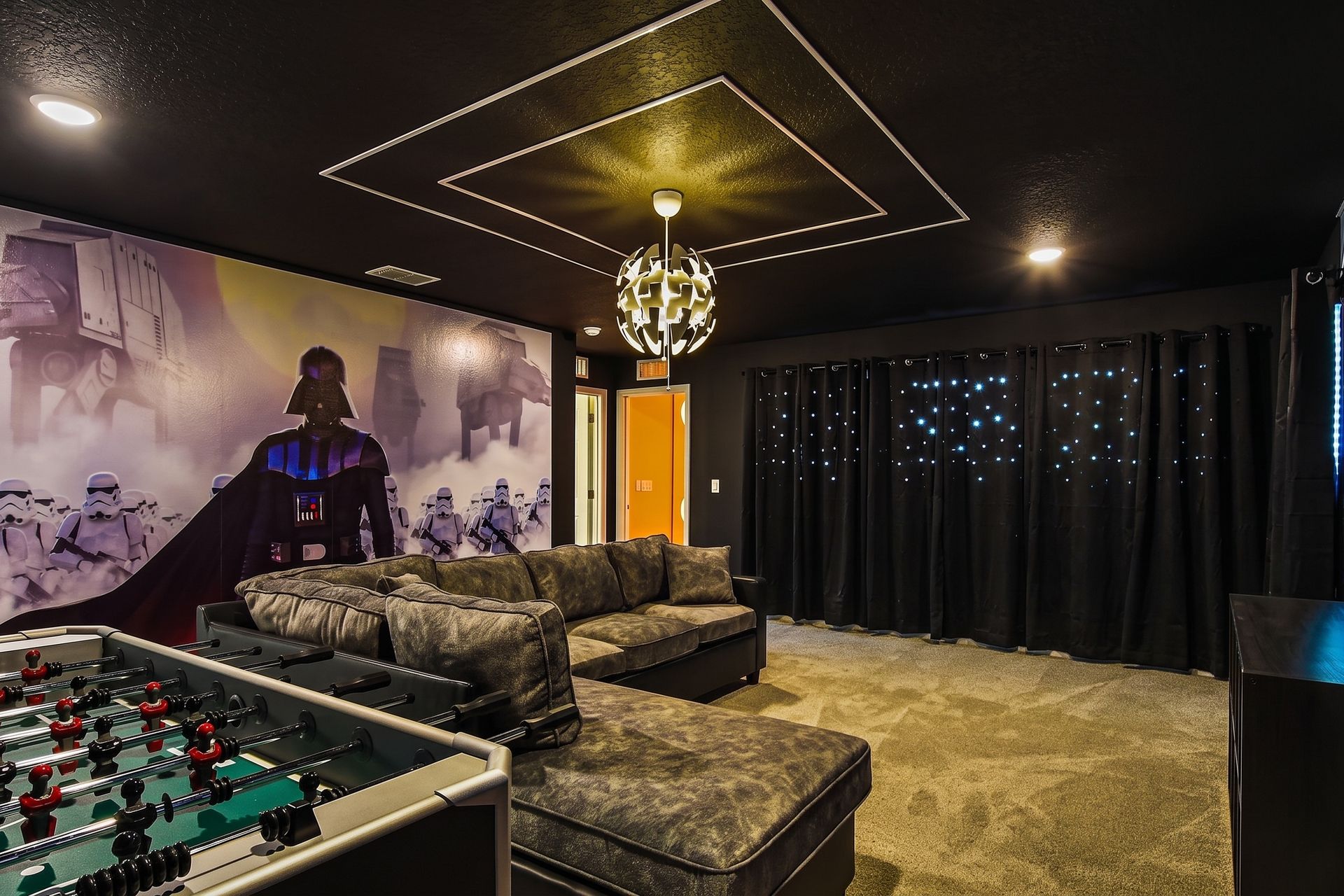 Epic game room with space-themed decor, foosball, basketball, and cozy lounge seating.