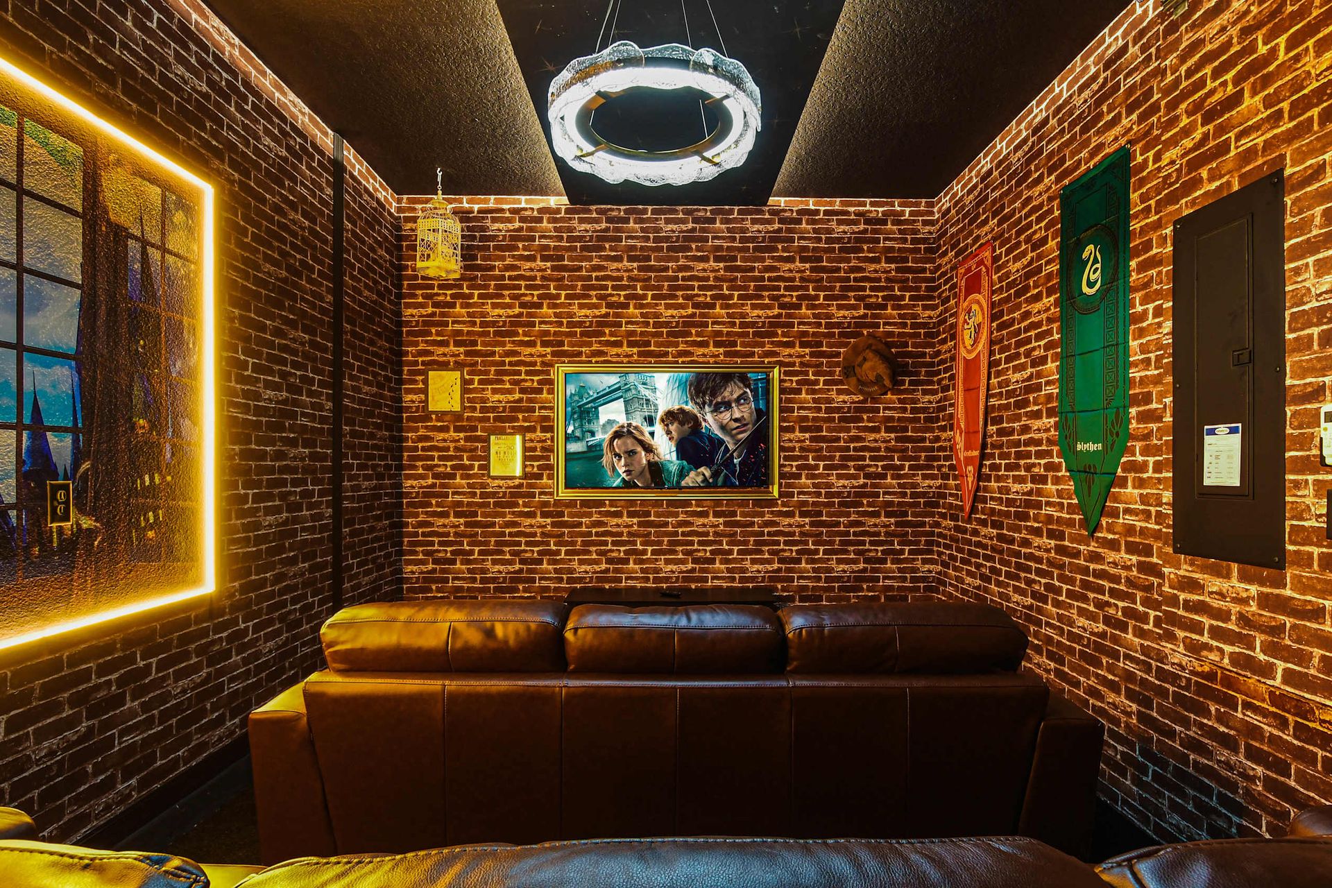 Magical theater room with house banners, glowing art, and plush leather seating.