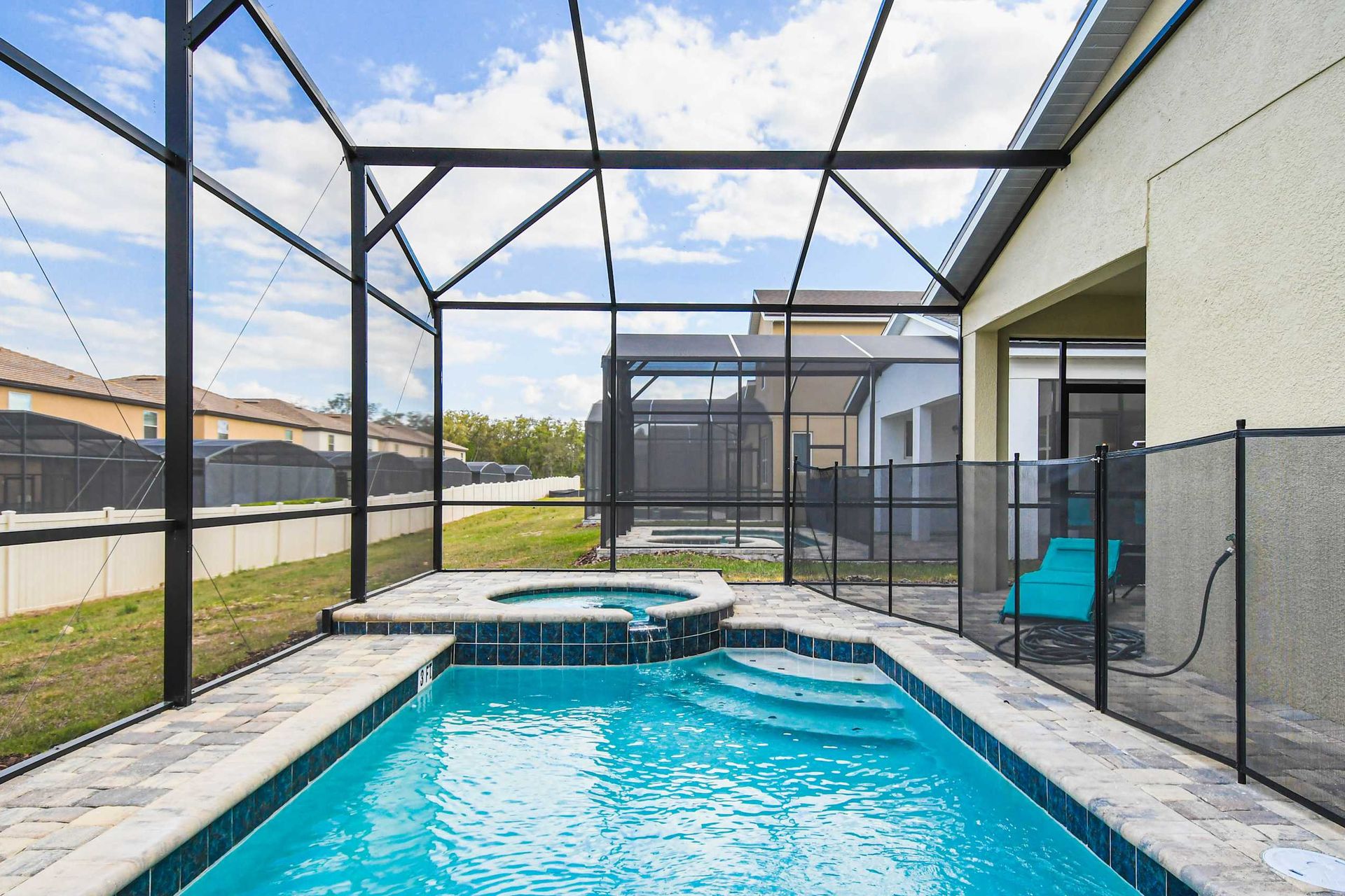 Private screened pool and spa with lounge area, perfect for relaxing and unwinding.