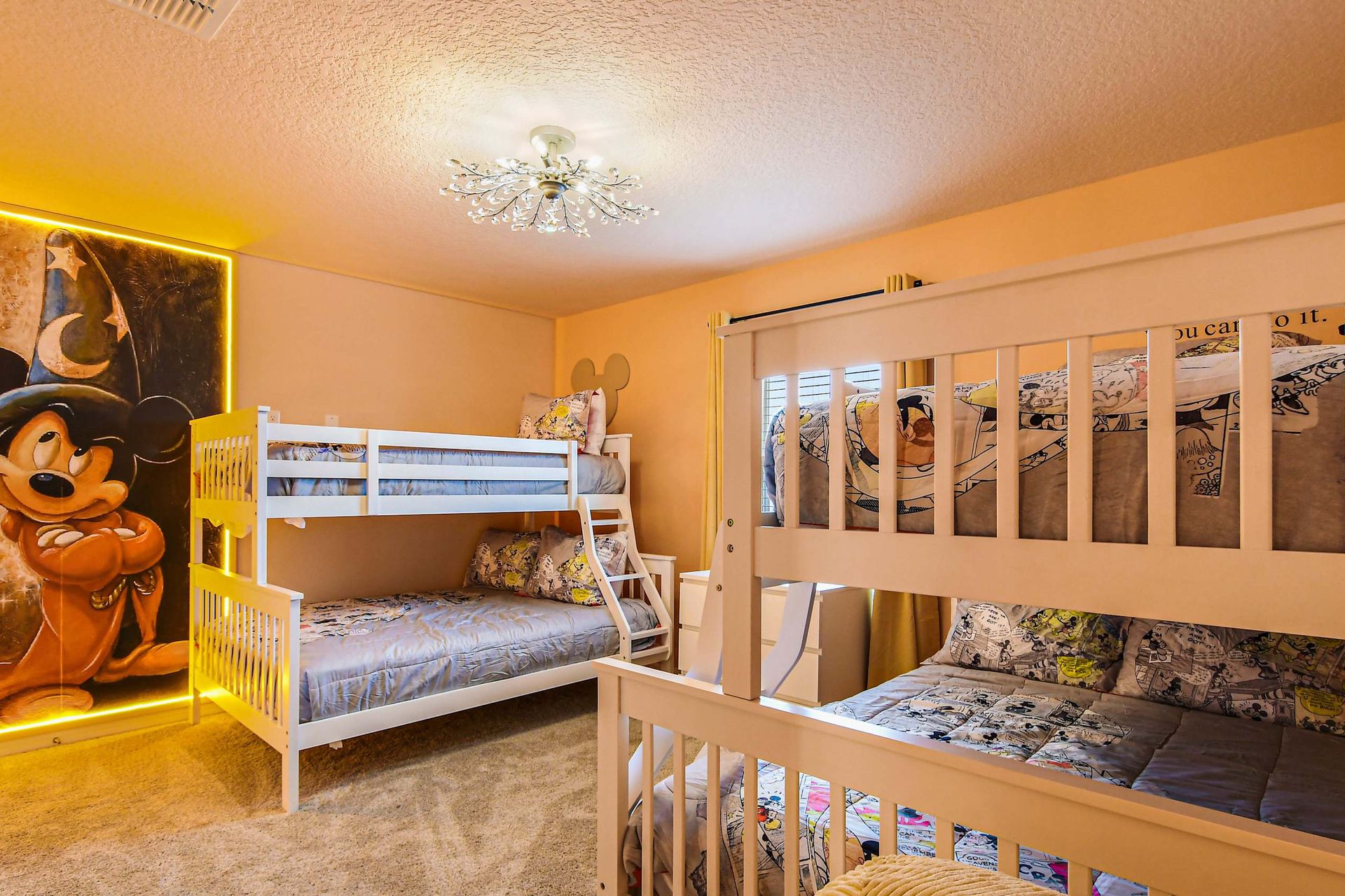 Fun-filled kids’ room with double bunk beds, playful decor, and glowing character mural.