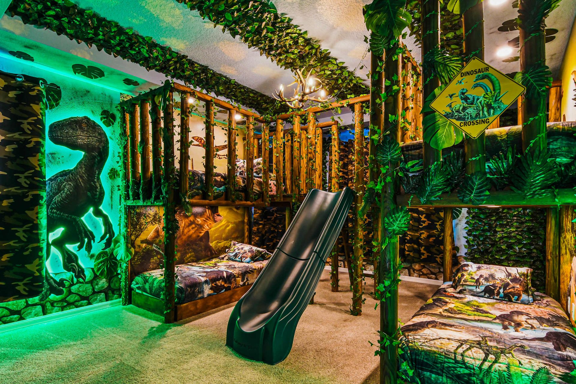 Jurassic bunk room with slide and jungle vibes for epic kids' adventure stays.