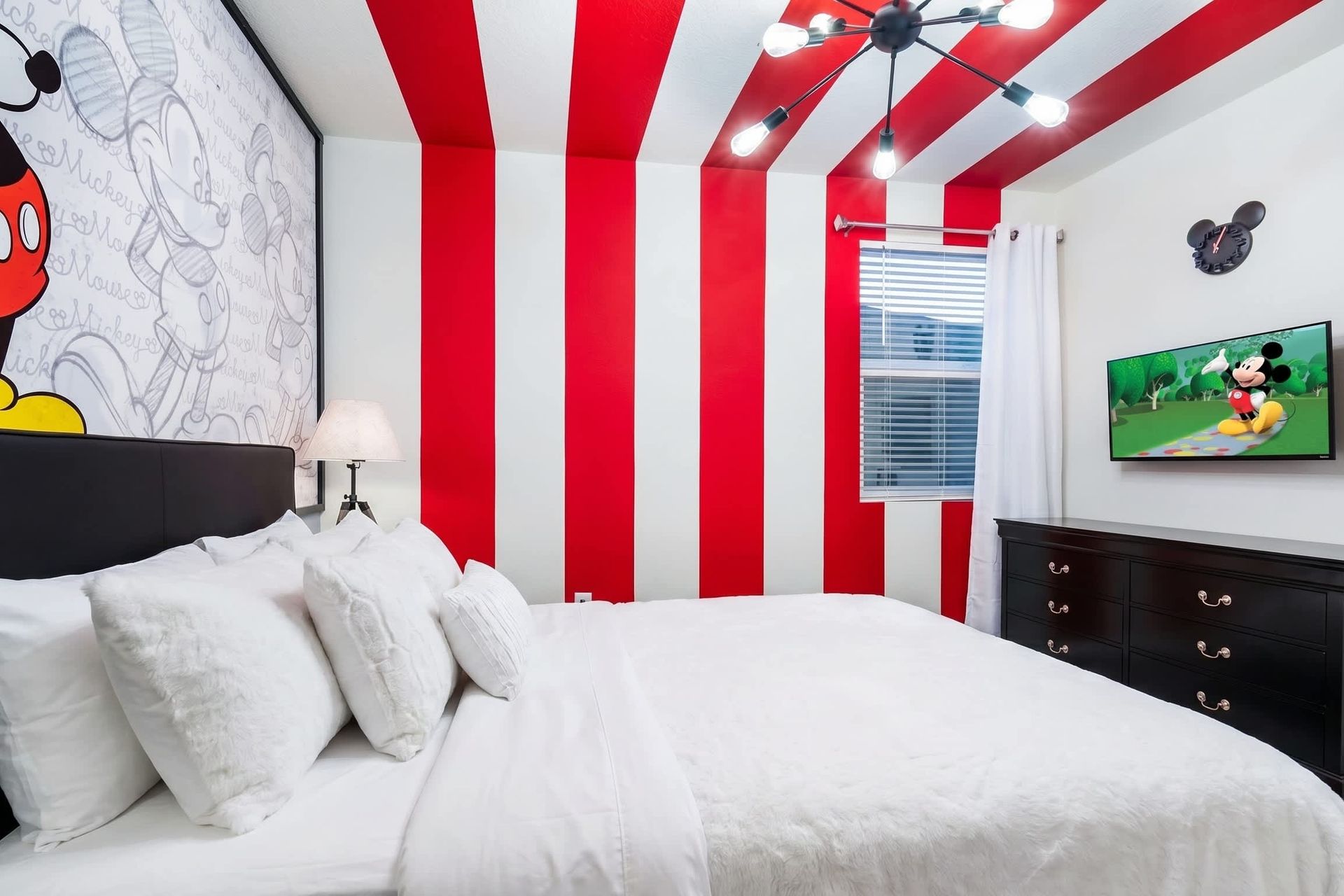 Cheerful Mickey Mouse-themed bedroom with bold stripes and fun decor!