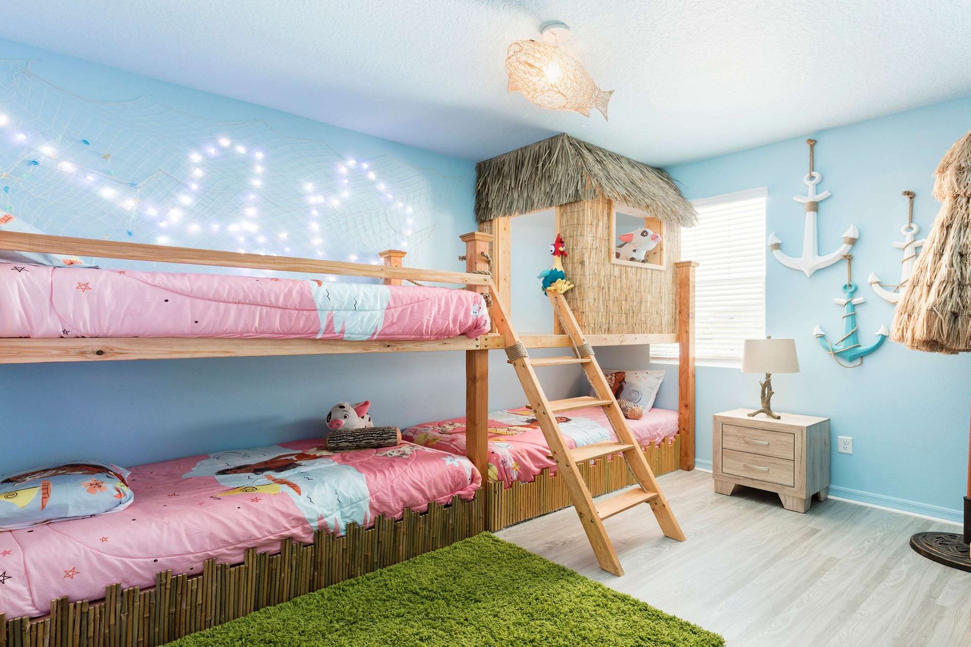 Tropical-themed kids' room with bunk beds, tiki hut, and fun decor!
