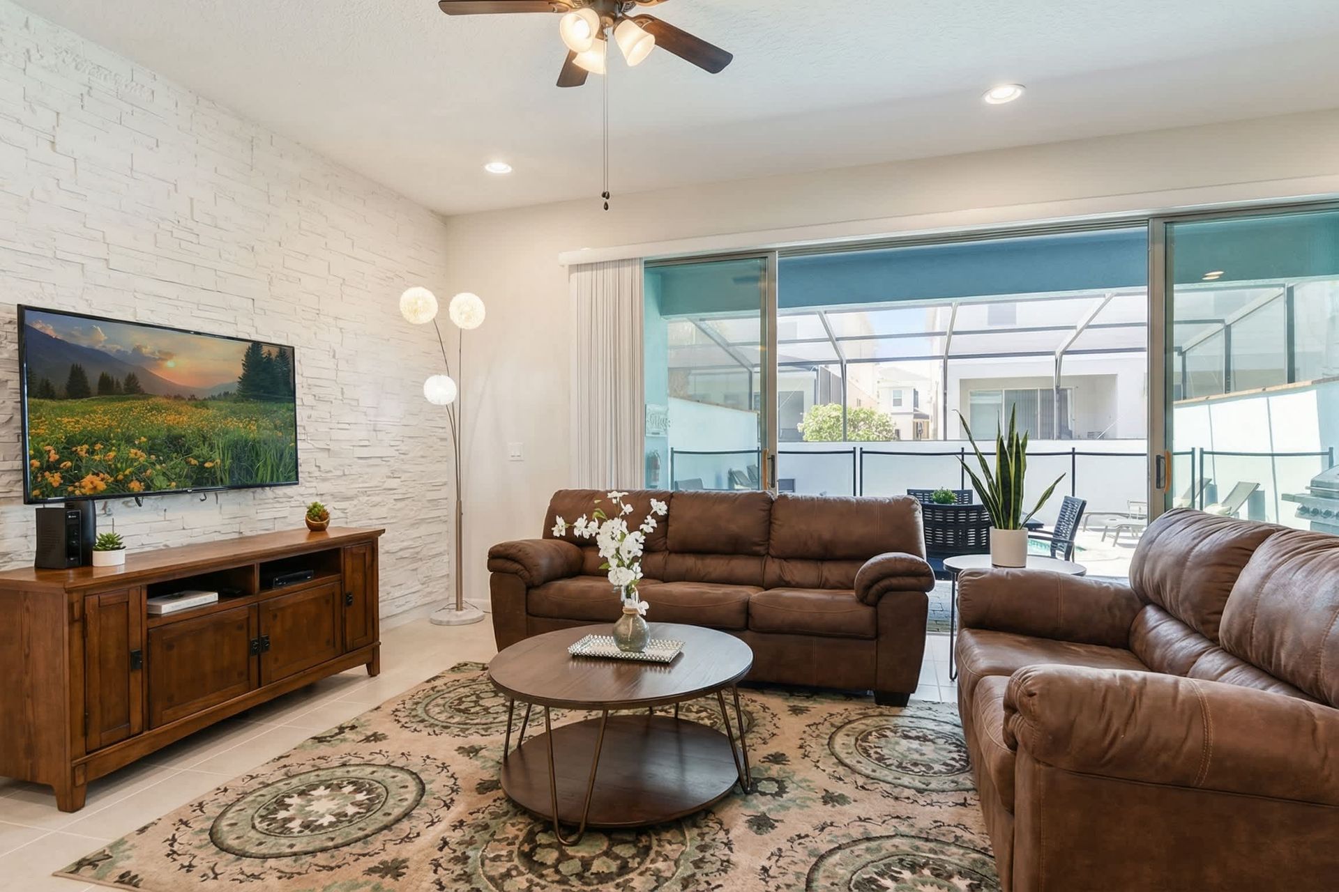 Relax in this cozy living room with poolside views and inviting modern comforts.