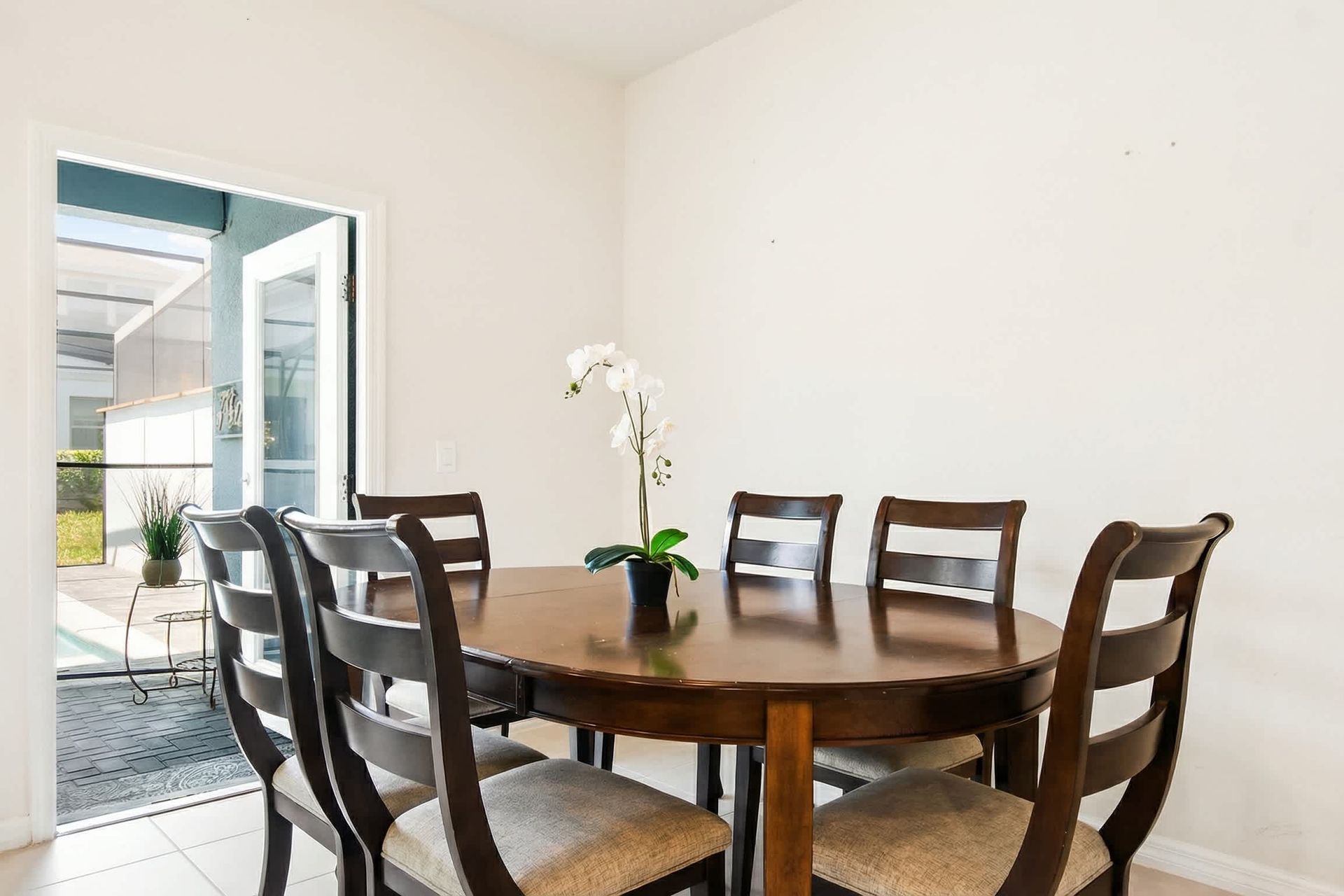 Cozy dining area with seating for six, steps away from the sunny poolside patio.