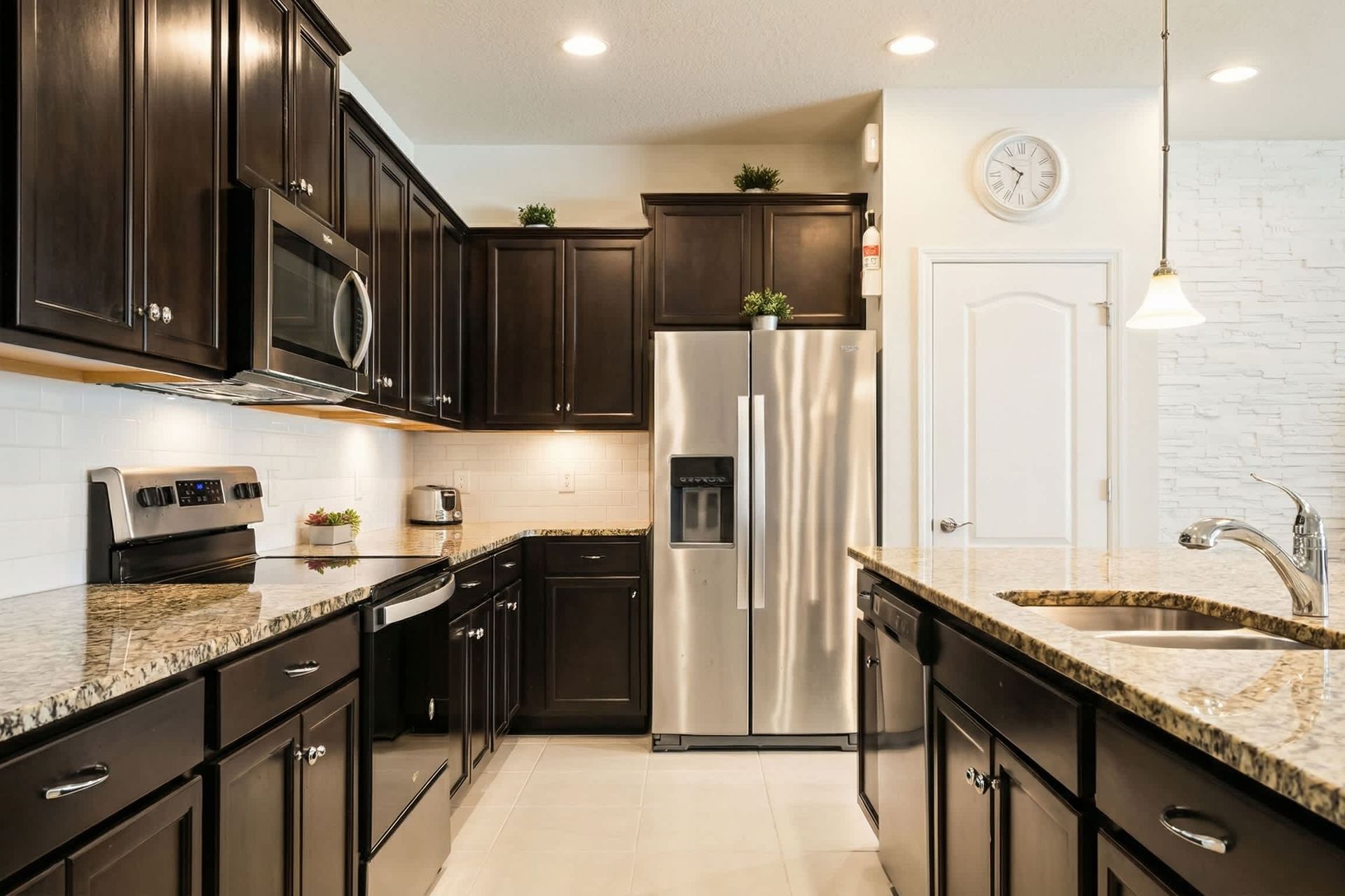 Modern kitchen with granite countertops, stainless steel appliances, and ample space.