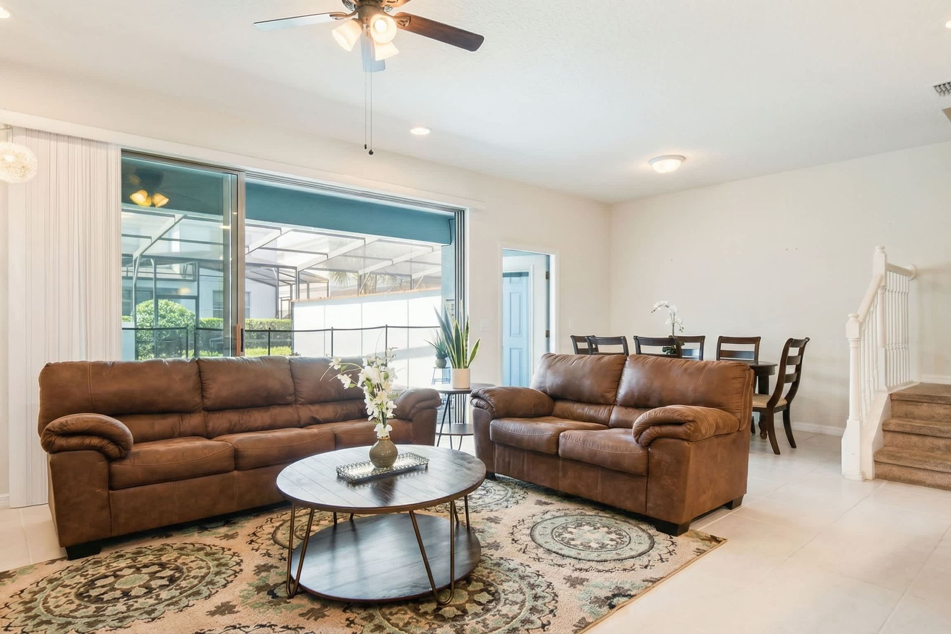 Bright open living and dining space with poolside views, perfect for relaxing stays.