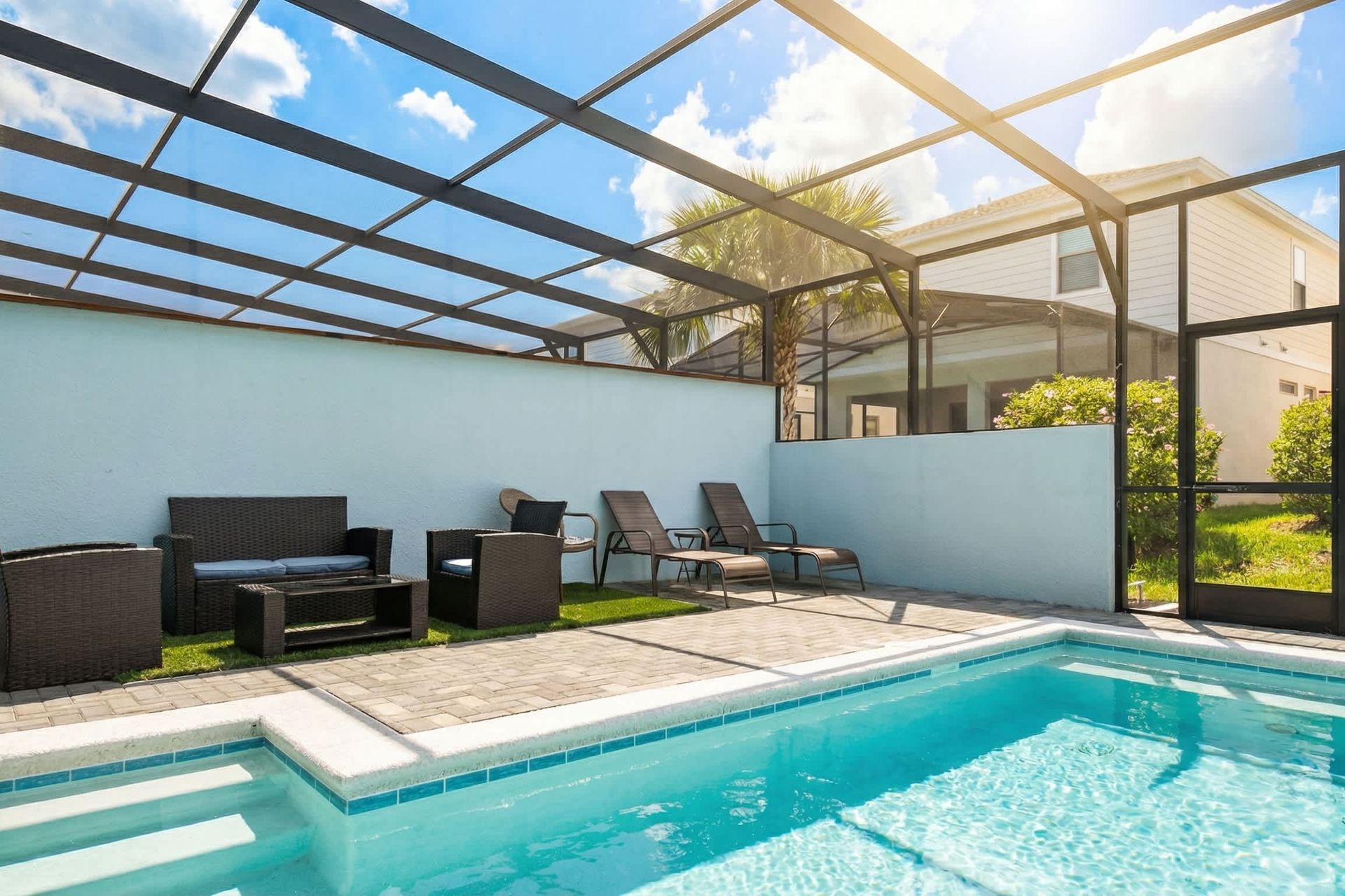 Sparkling private pool with loungers and comfy seating, ideal for sunny relaxation.