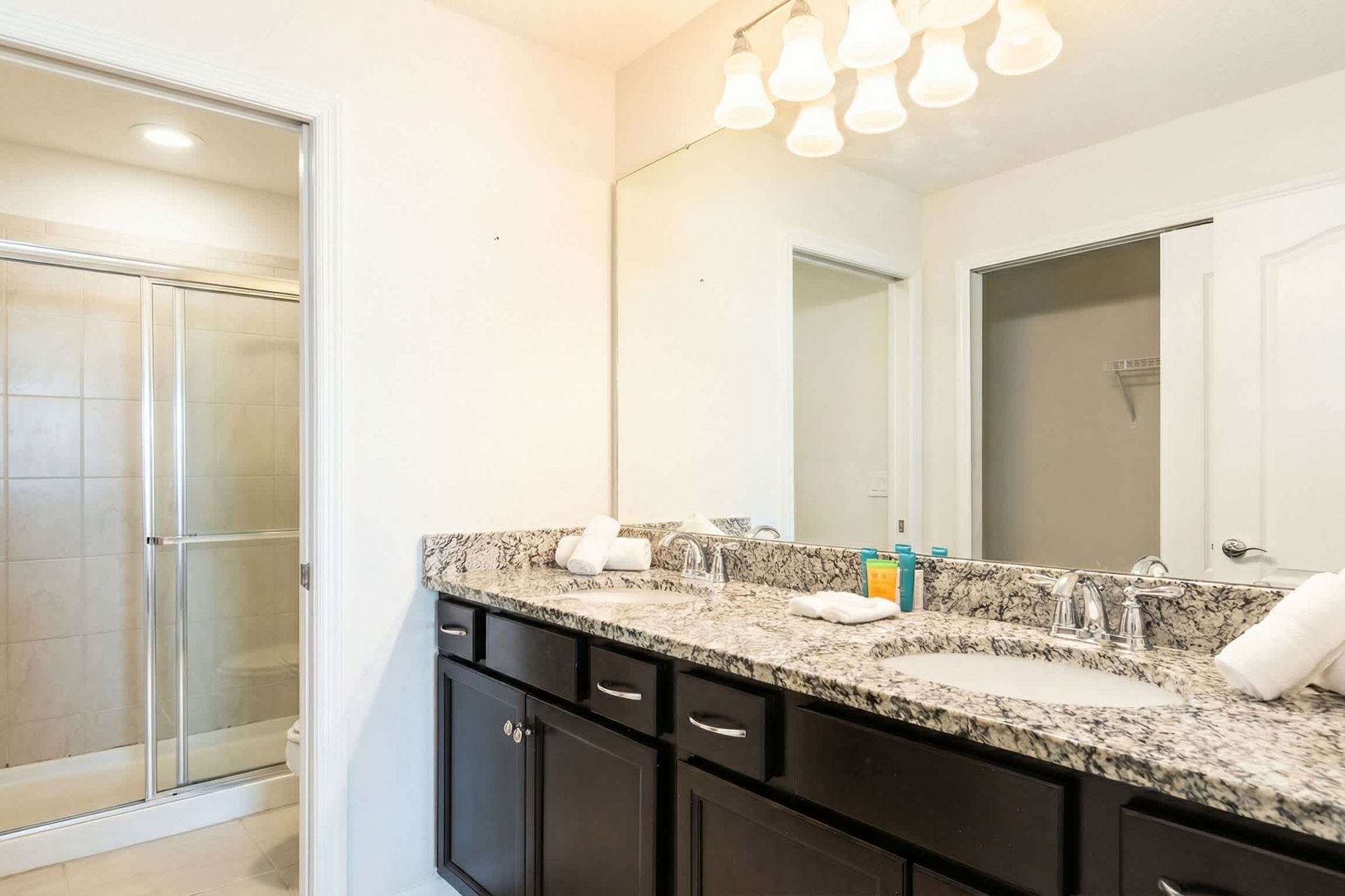 Spacious double-sink bathroom with walk-in shower, perfect for relaxing moments.