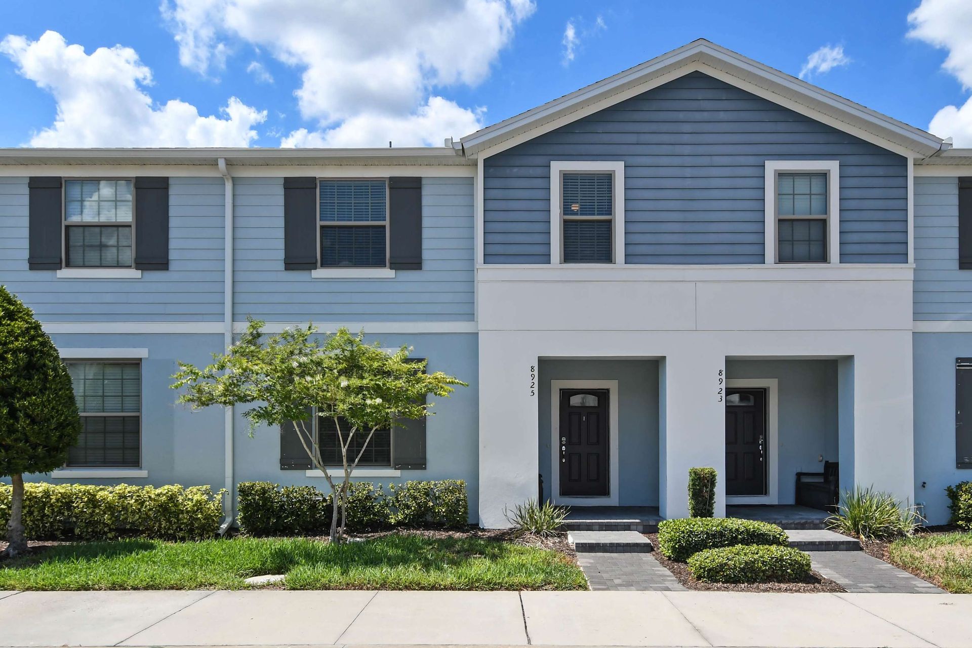 Charming modern townhouse with bright exterior and inviting private entrance.