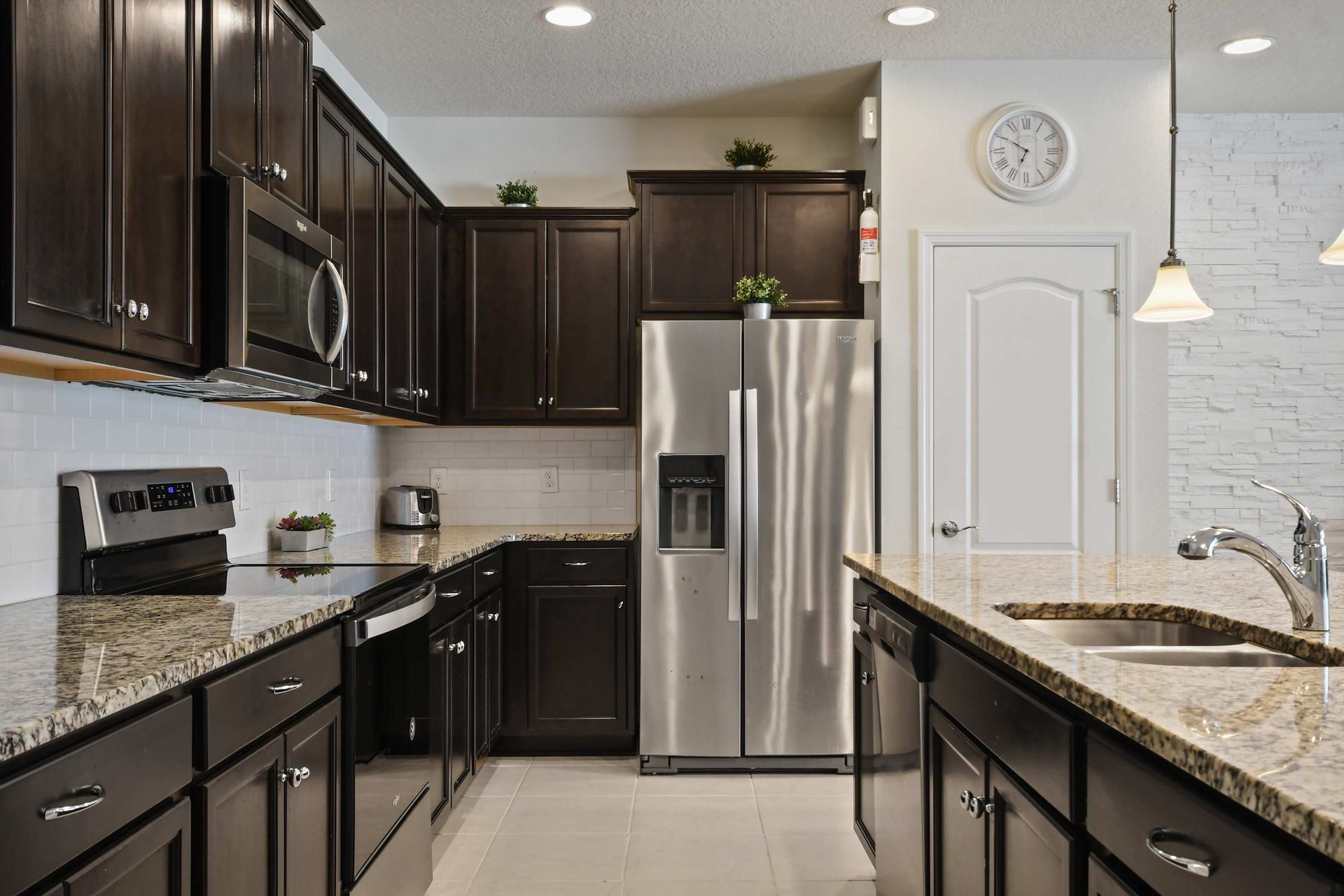 Modern kitchen with granite countertops, stainless steel appliances, and ample space.