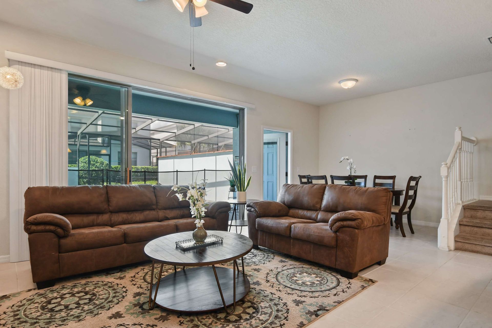 Bright open living and dining space with poolside views, perfect for relaxing stays.