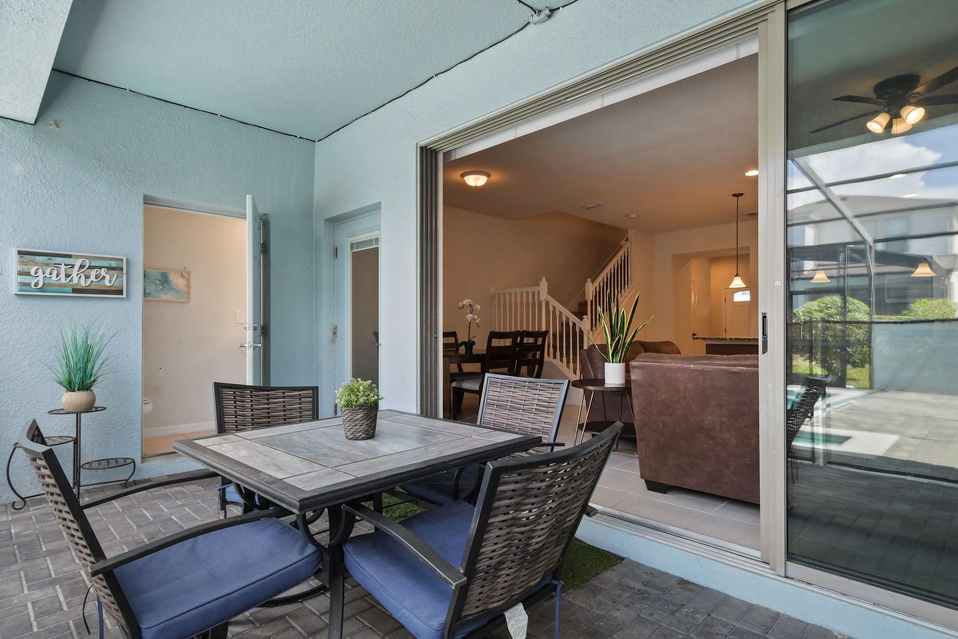 Charming covered patio with dining space, perfect for outdoor meals by the pool.
