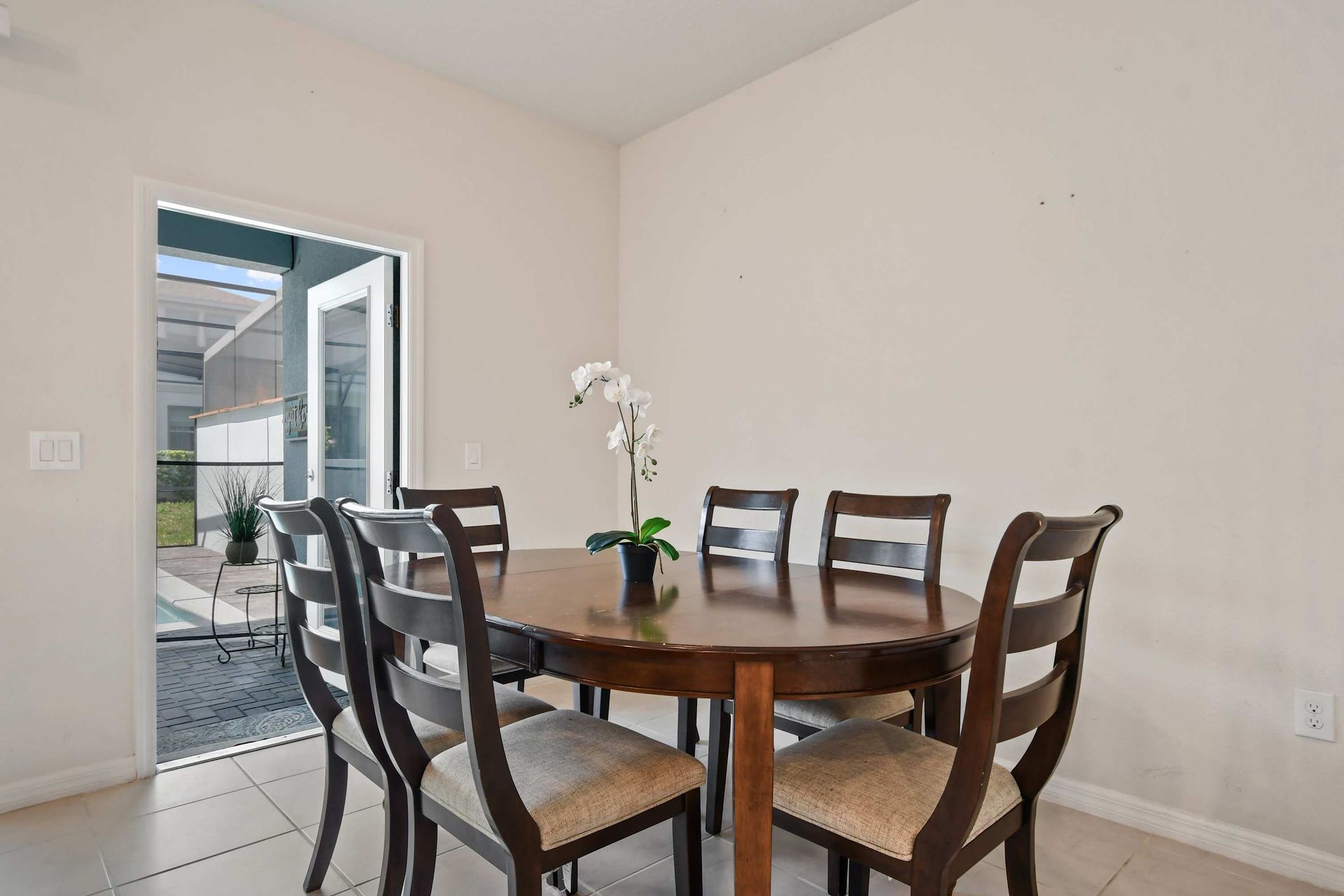 Cozy dining area with seating for six, steps away from the sunny poolside patio.